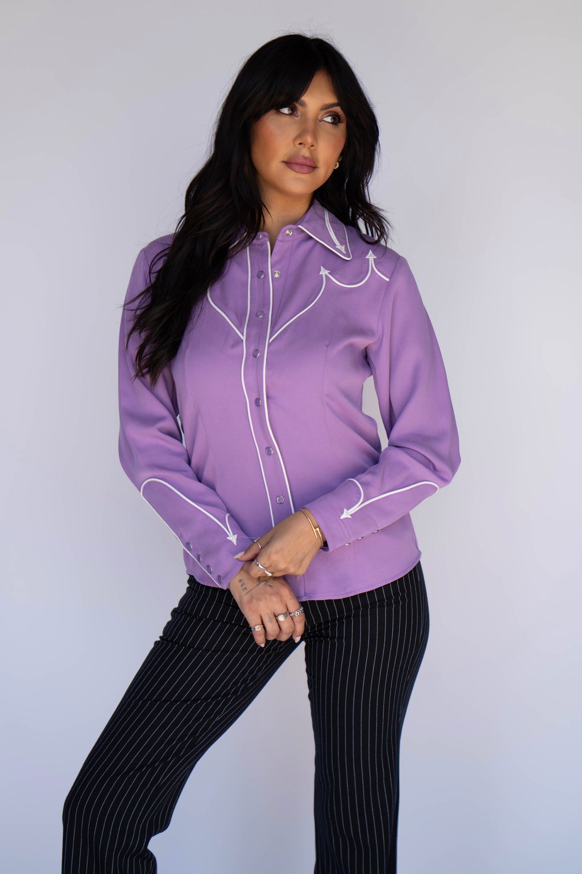 Full length view of the H Bar C Lake Tahoe women's lavender shirt with black pinstripe trousers.