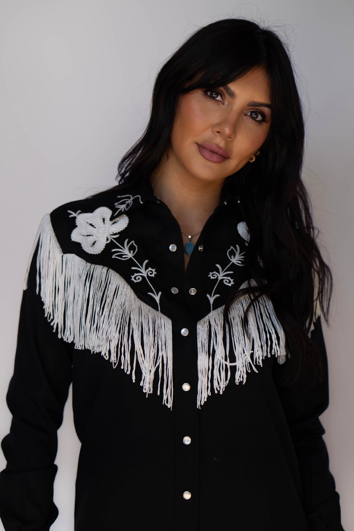 Close-up of the white fringe and embroidered yoke on the H Bar C Roswell black dress.