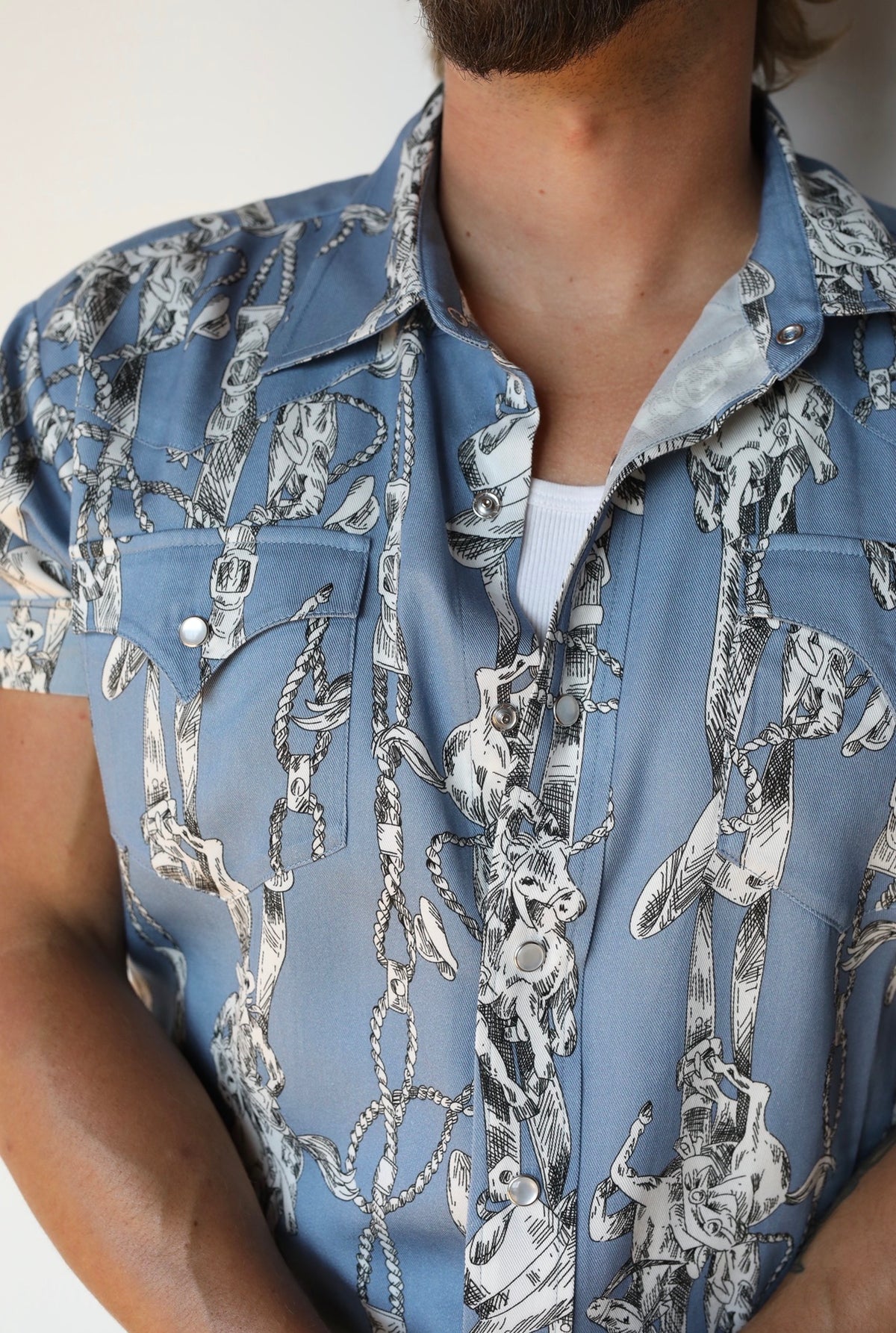 Close-up of the light blue and cream print and pearl snaps on the H Bar C Newport Breckenridge shirt.