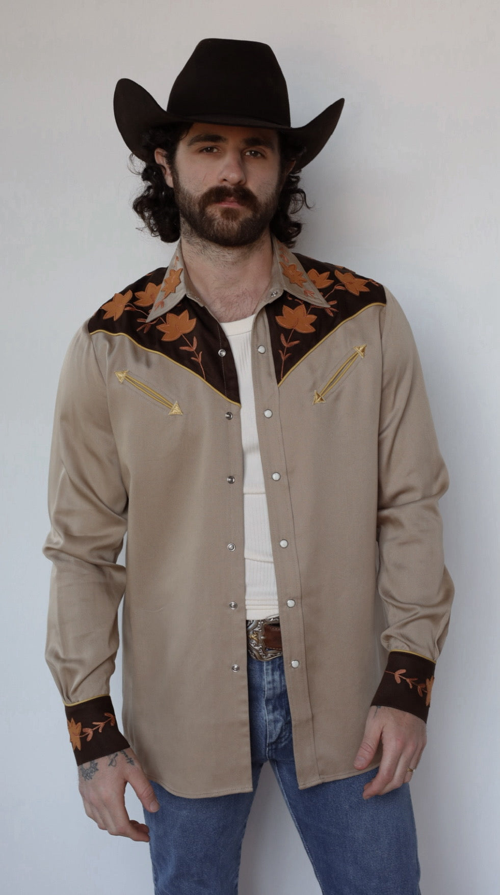 H Bar C Stowe western shirt worn open over a white tee with a black cowboy hat.