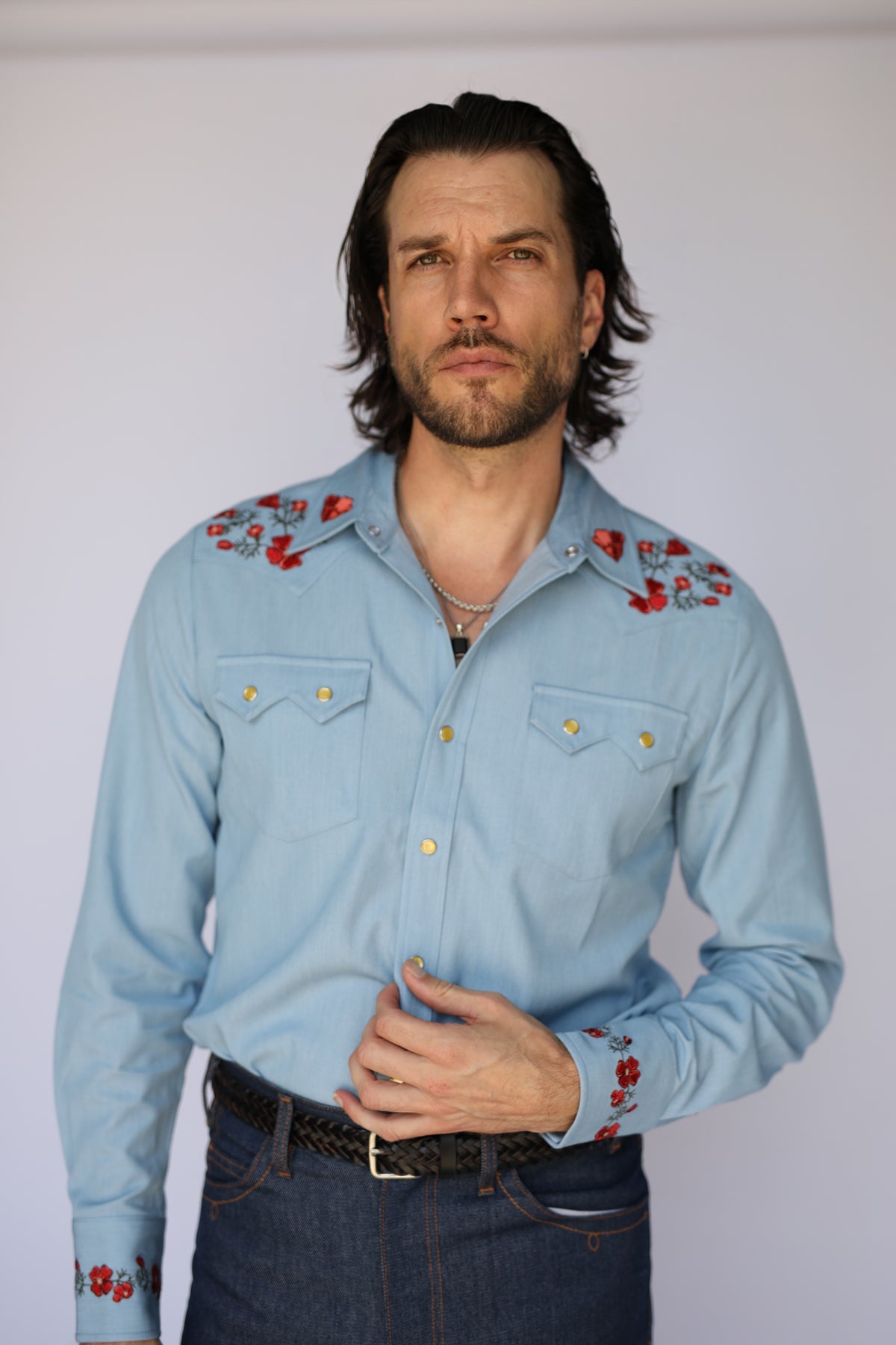 Man wearing the HBarC x Gibson Dove light blue western shirt tucked into jeans, 1960s Laurel Canyon inspired style.