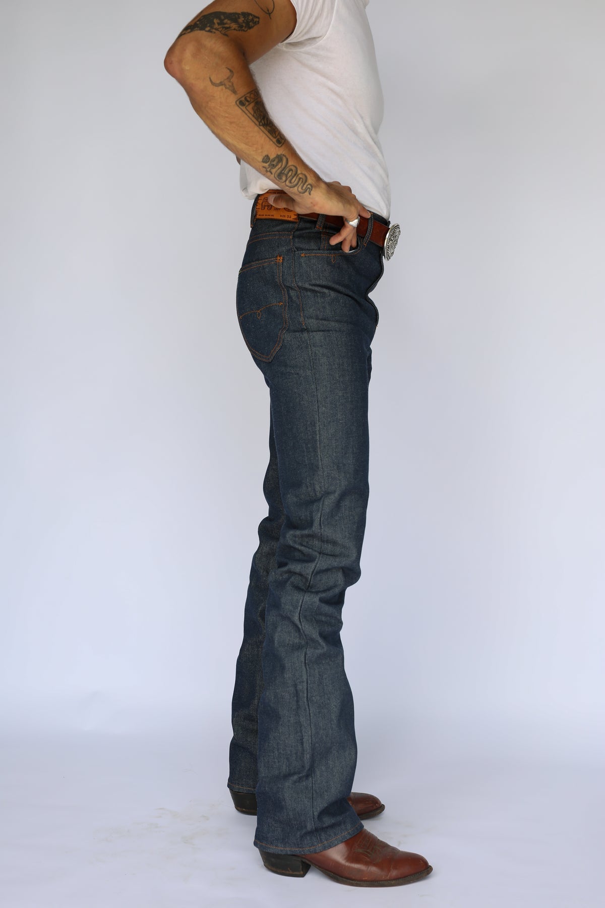 Side view of the H Bar C Salina indigo slim straight jeans with cowboy boots.