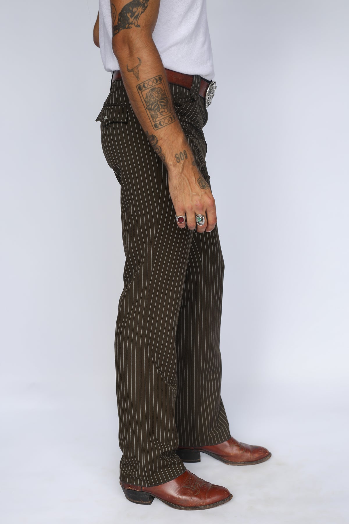 Side view of the H Bar C Bakersfield brown pinstripe pants showing the slim straight leg and boot break.