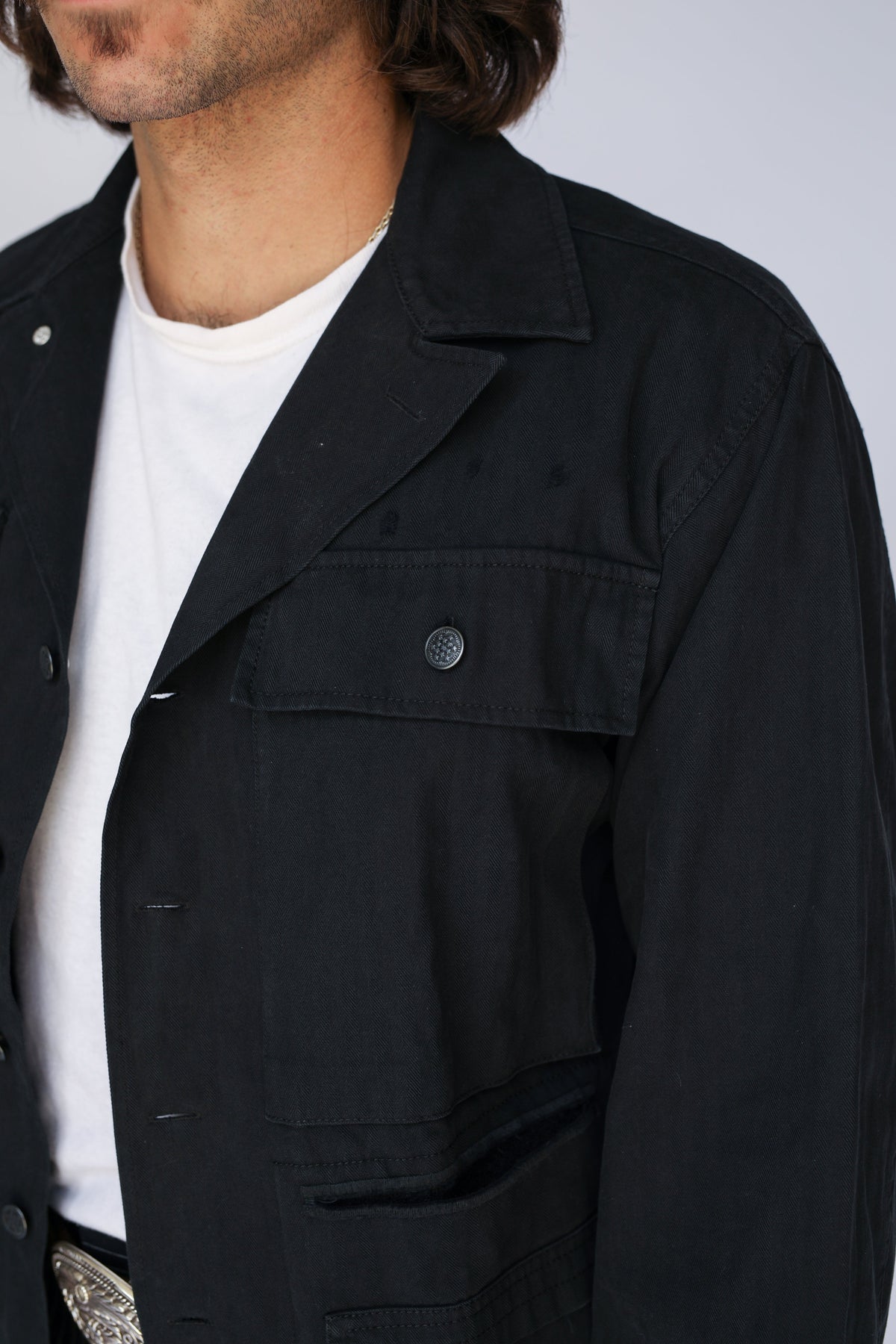 Close-up of the H Bar C Normandy black chore coat over a white tee.