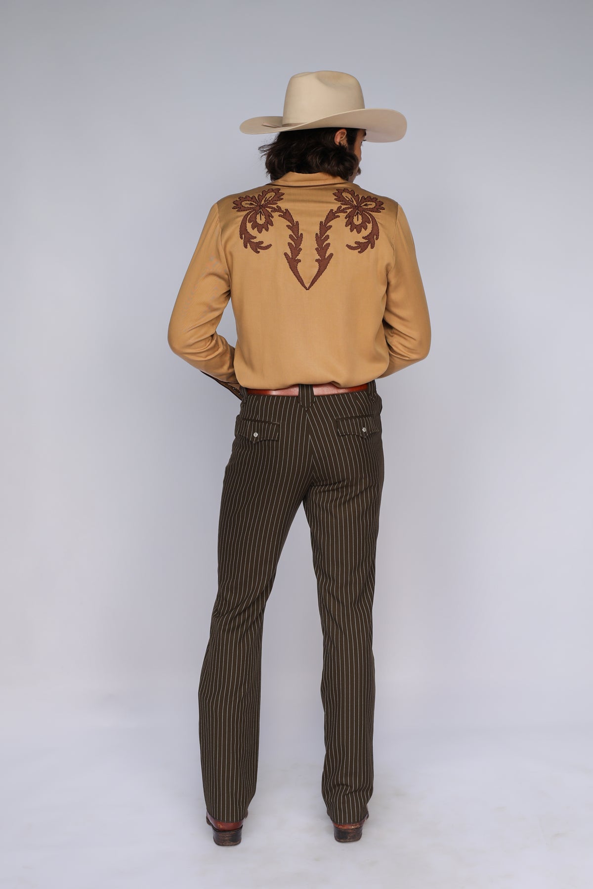 Full back view of the H Bar C Terlingua western shirt with pinstripe pants and cowboy hat.