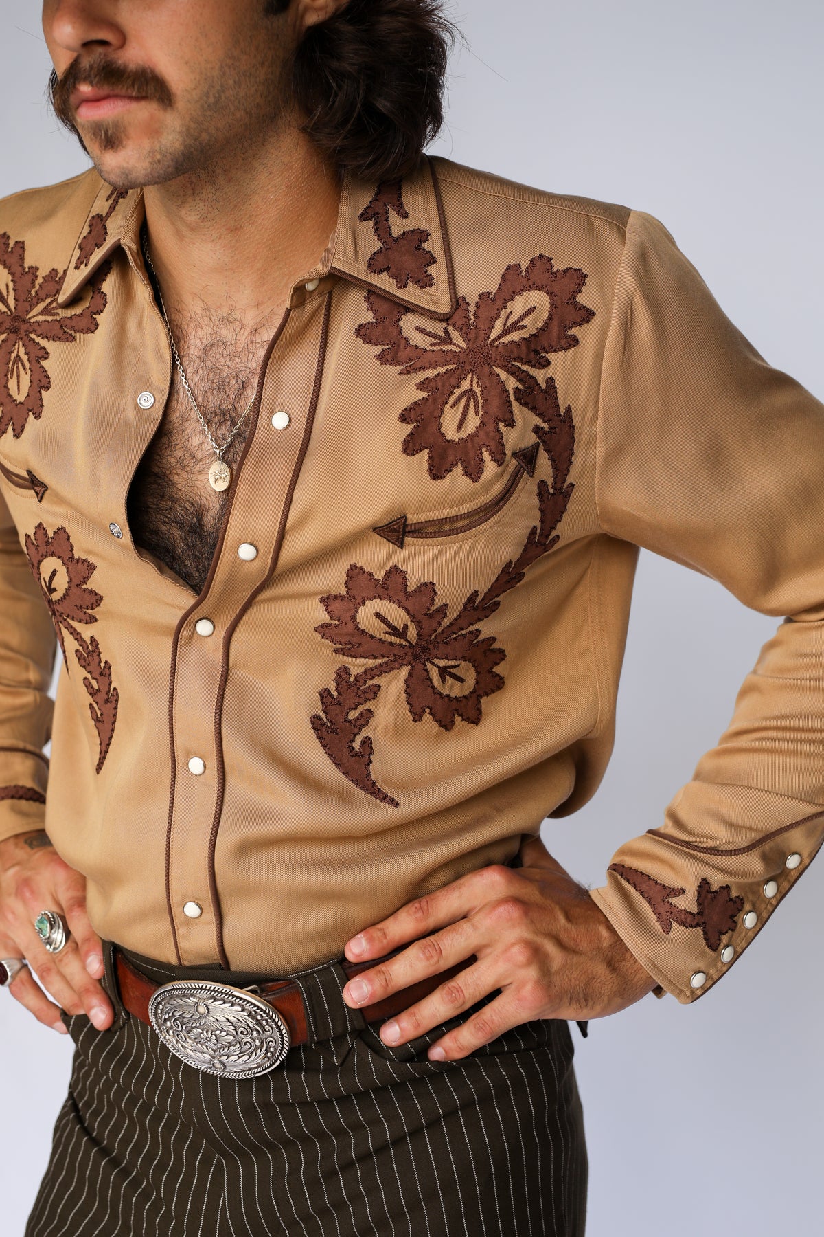 Detail of the brown chain stitch scrollwork and pearl snaps on the H Bar C Terlingua shirt.