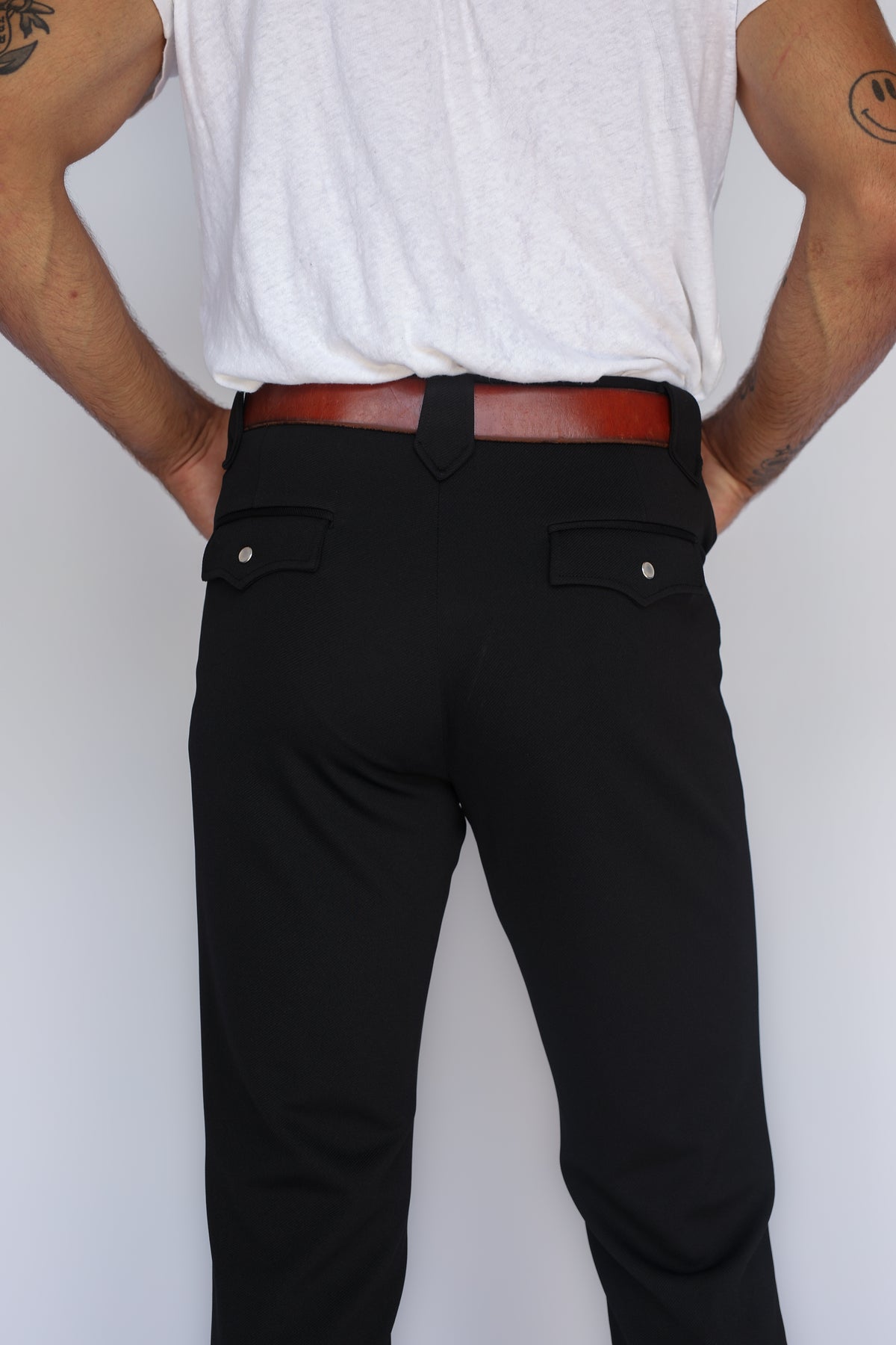 Close-up of the back pockets and fit of the H Bar C Bolero men's black western pants.