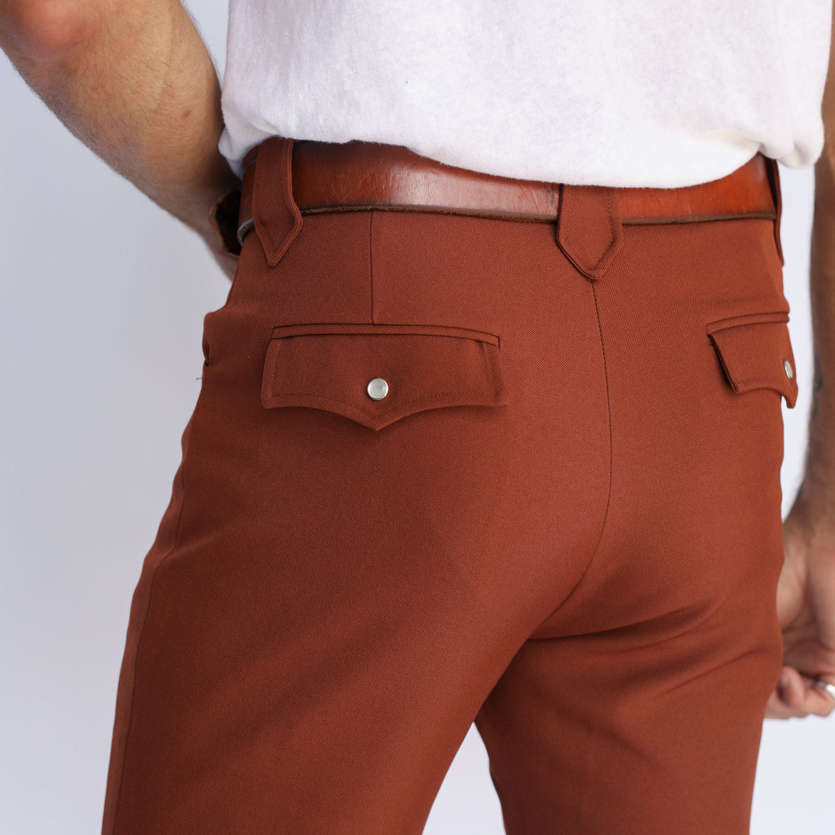 Back pocket close-up of the H Bar C Franklin brown western pants with brown belt.