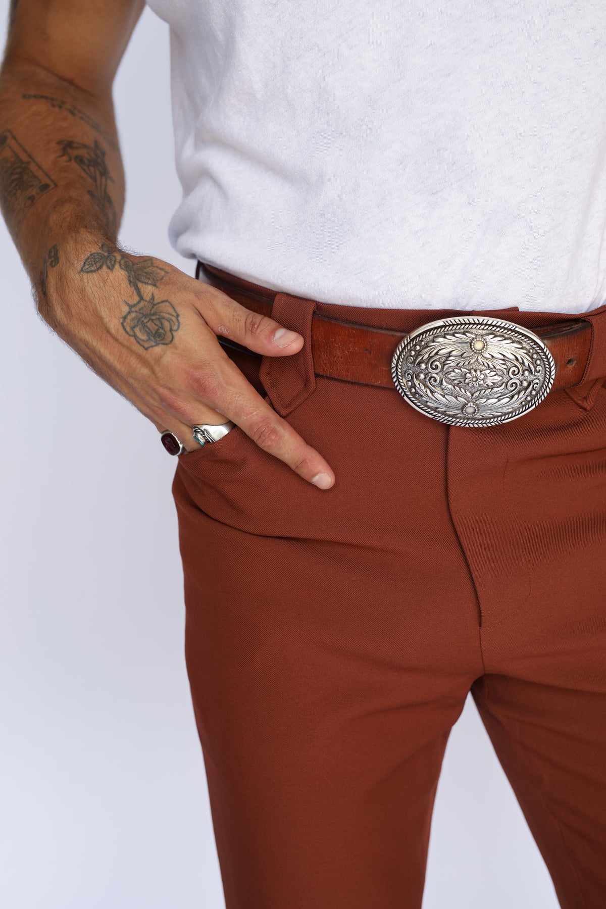 Close-up of the front pocket and silver buckle on the H Bar C Franklin brown western pants.