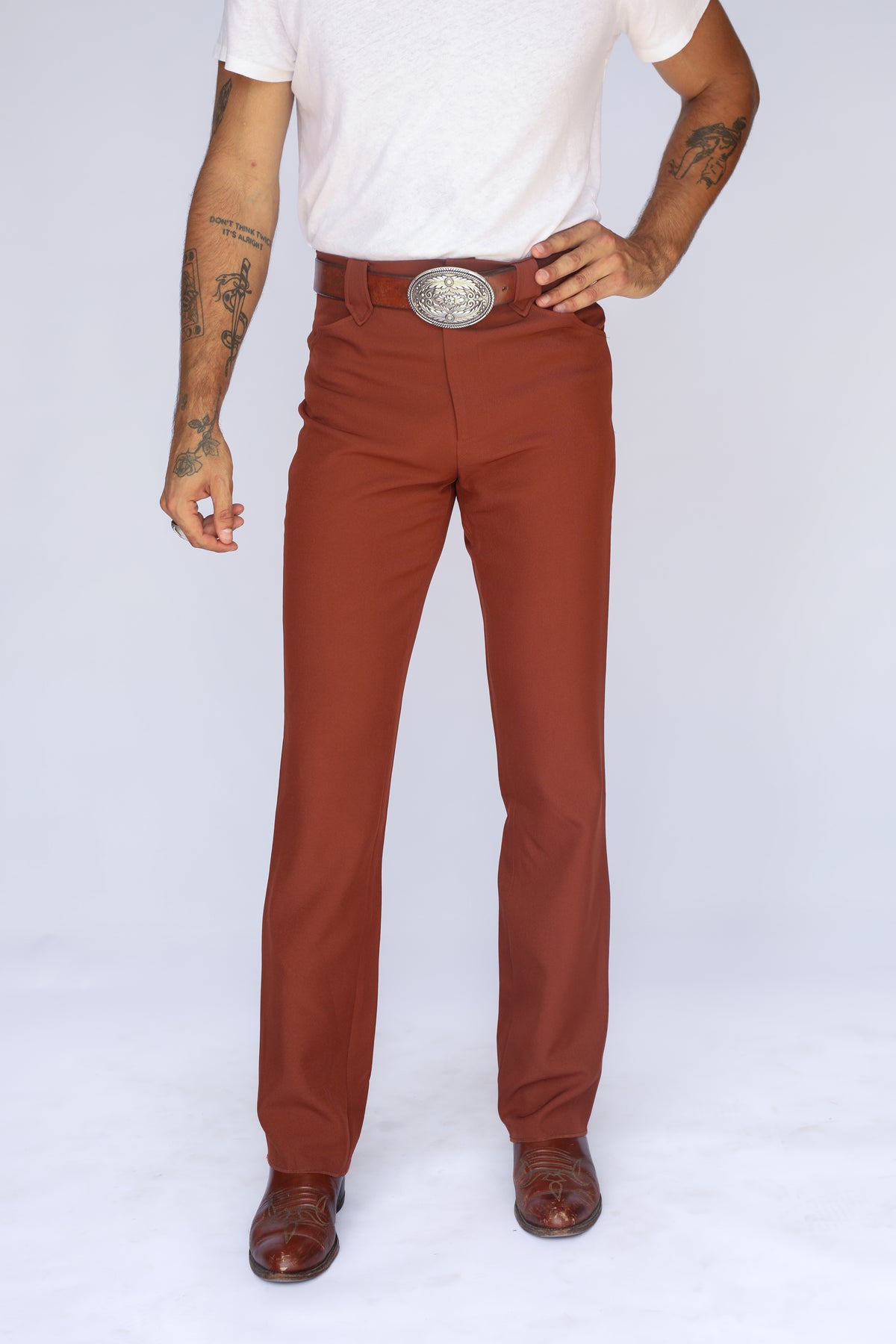 H Bar C Franklin brown stretch western pants with a straight leg over cowboy boots.