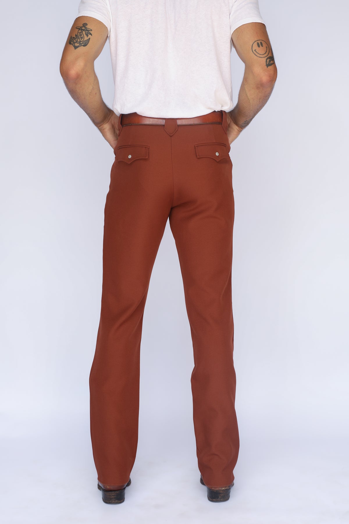 Front view of the H Bar C Franklin unisex brown pants with a white tee.