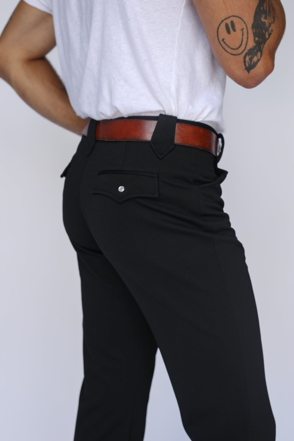 Three-quarter back view of the H Bar C Franklin black western pants showing the fit and western back pocket.