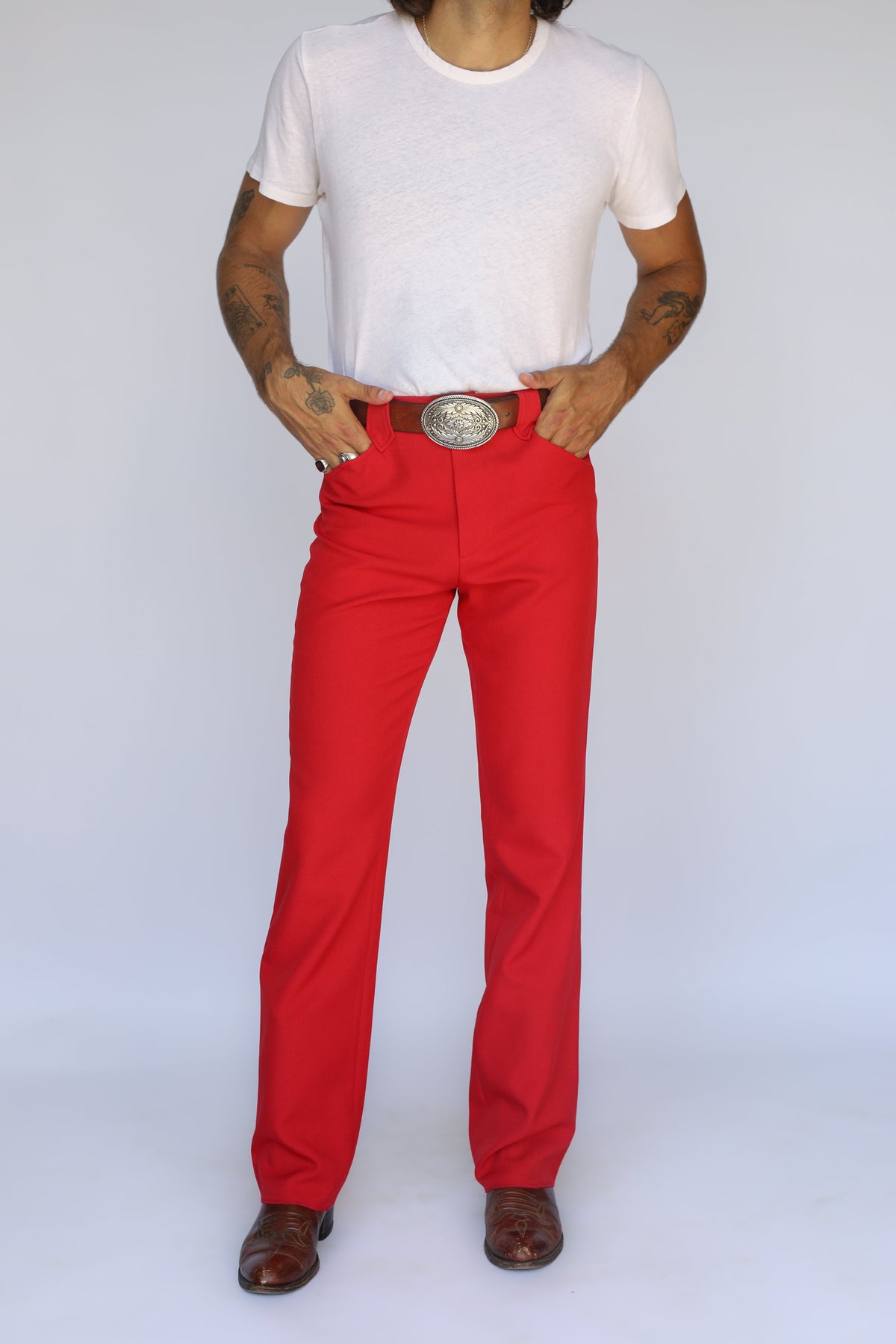 Front view of the H Bar C Franklin unisex western pants in red, a stretch western dress pant worn with a silver buckle.