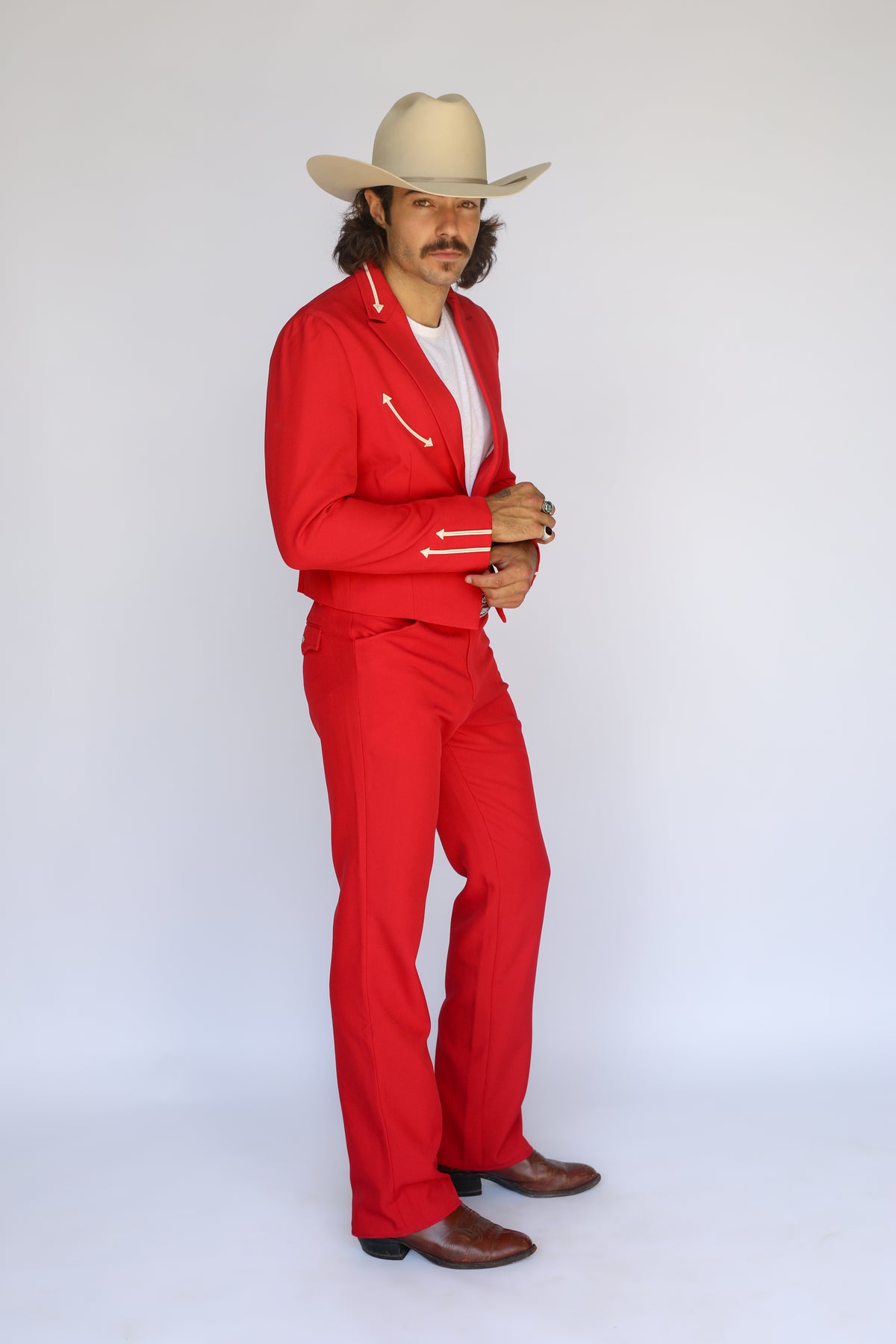 Three-quarter view of the H Bar C Calamity men's red jacket and red western pants.