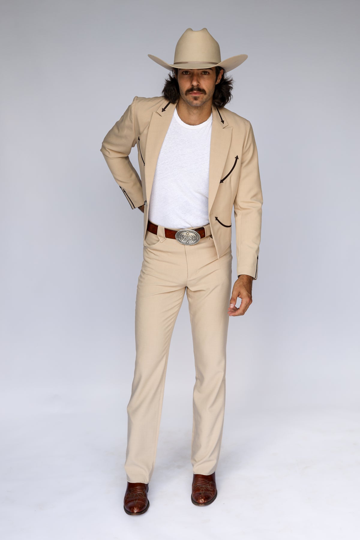Front view of the H Bar C Calamity tan western jacket designed by Jess Carson, worn open with matching pants.