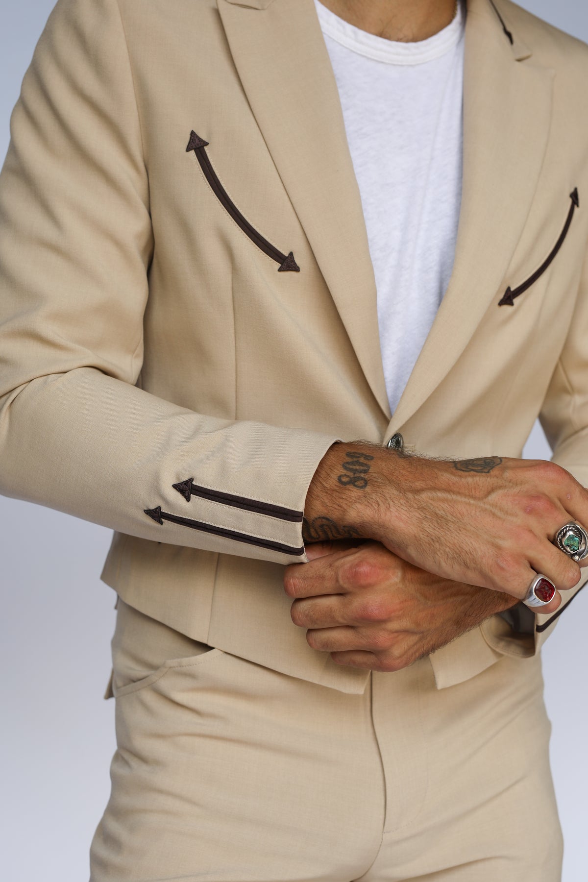 Close-up of the H Bar C Calamity jacket in tan with brown arrow smile pockets and cuffs.