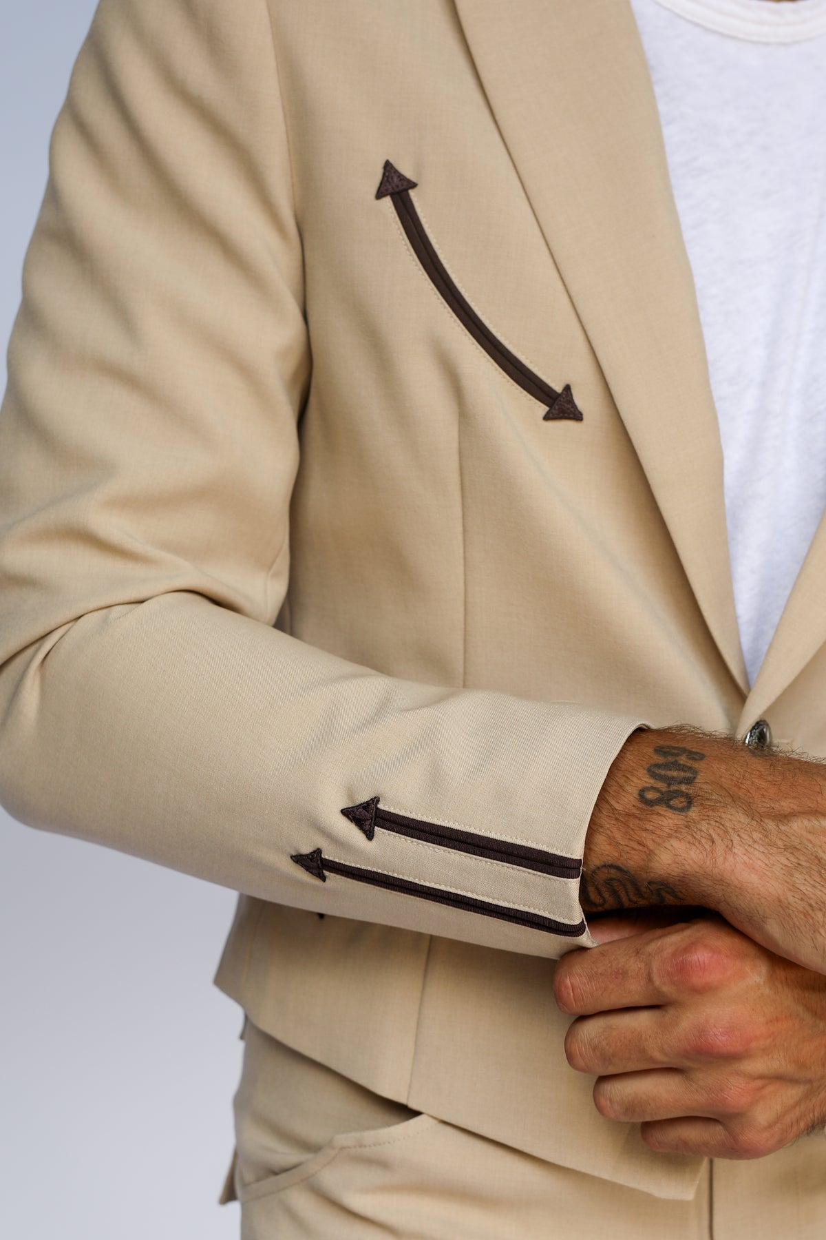 Sleeve detail of the H Bar C Calamity tan jacket with brown embroidered arrows.