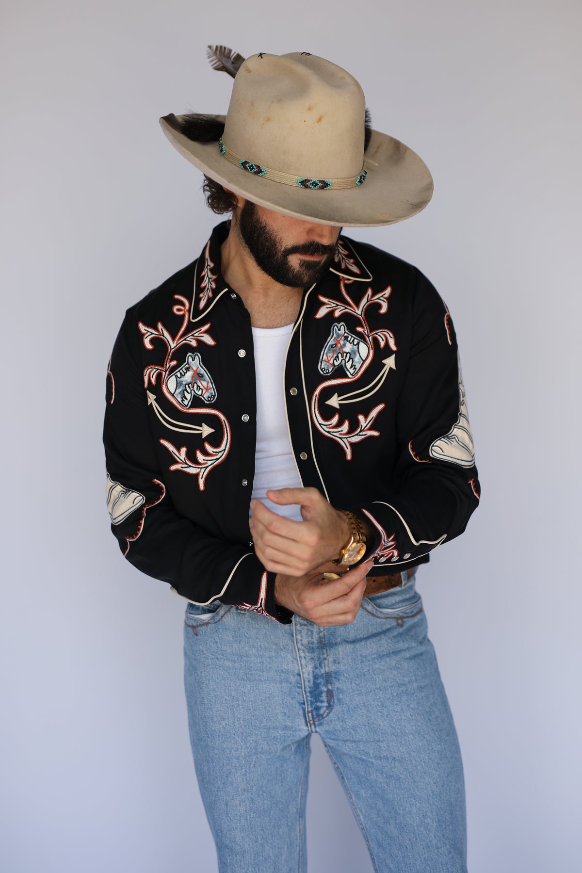 Front view of the H Bar C Calabasas black embroidered western shirt with light jeans.