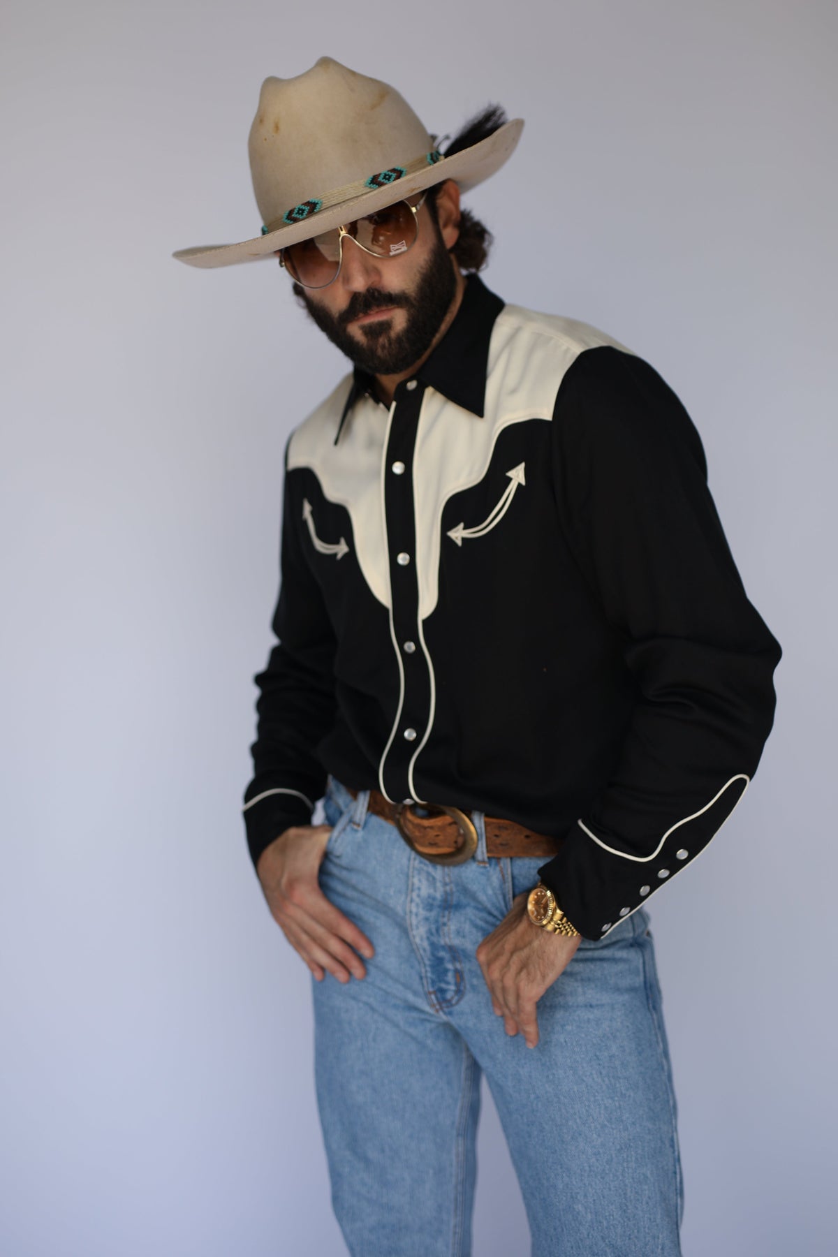 Three-quarter view of the H Bar C San Juan men's black and cream two-tone pearl snap shirt with rodeo cuffs.