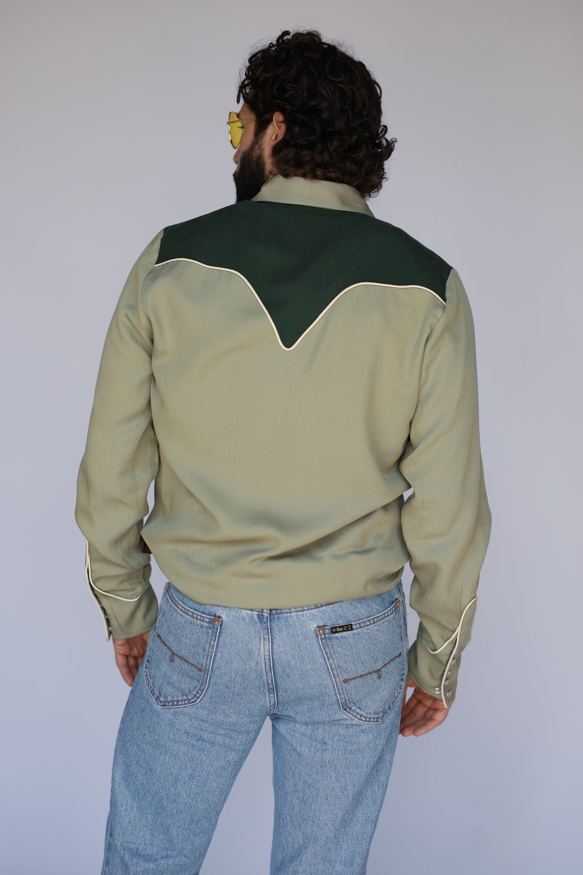 Back view of the H Bar C San Juan green western shirt showing the dark green back yoke with cream piping.