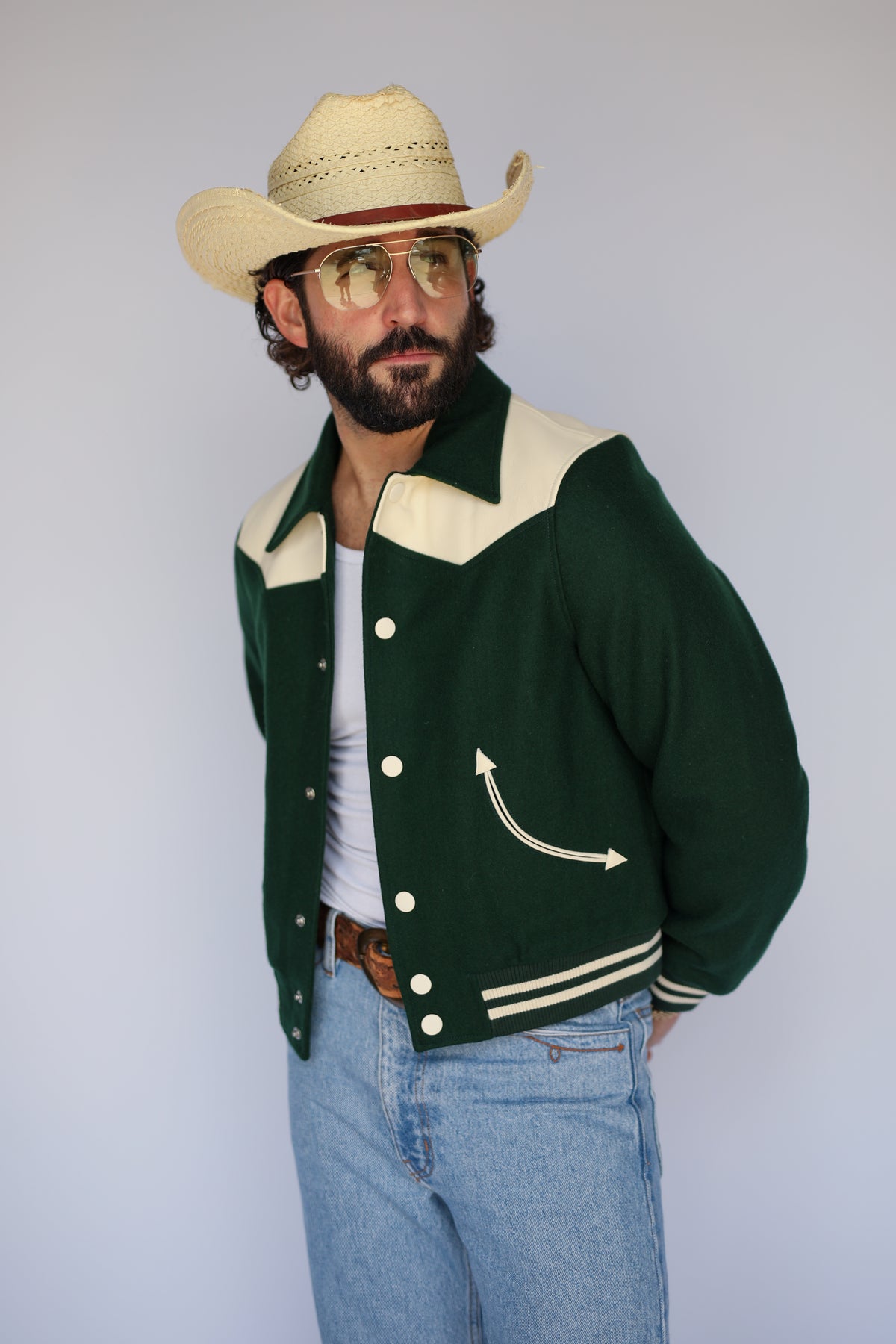 Three-quarter view of The Vail unisex green jacket by H Bar C with cream arrow pockets.