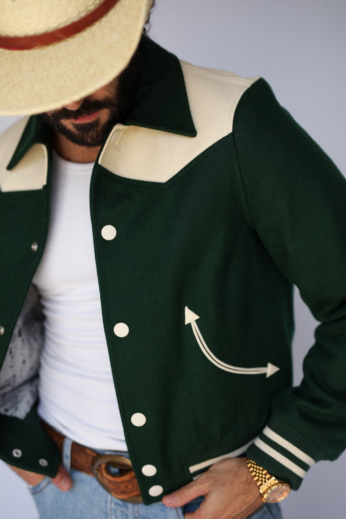 Close-up of the cream yoke and arrow pocket on The Vail H Bar C green jacket.