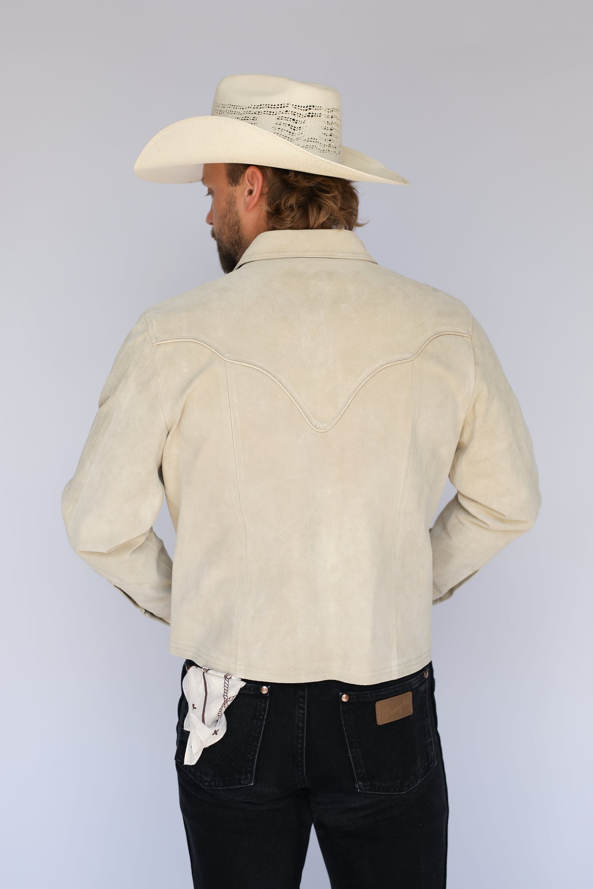 Back view of the H Bar C Austin stone suede jacket with a cream cowboy hat.