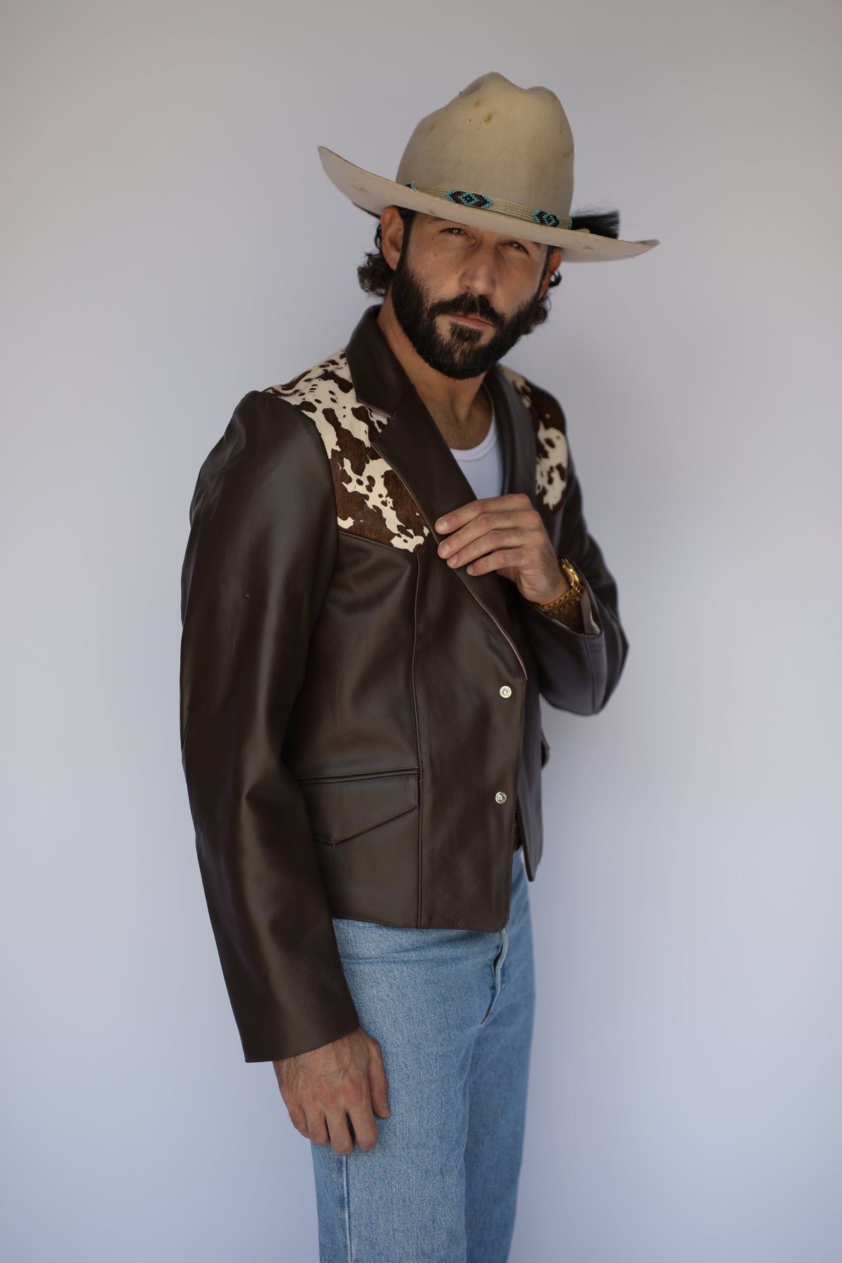 Side view of the H Bar C Cody brown leather western jacket with cowhide shoulders.