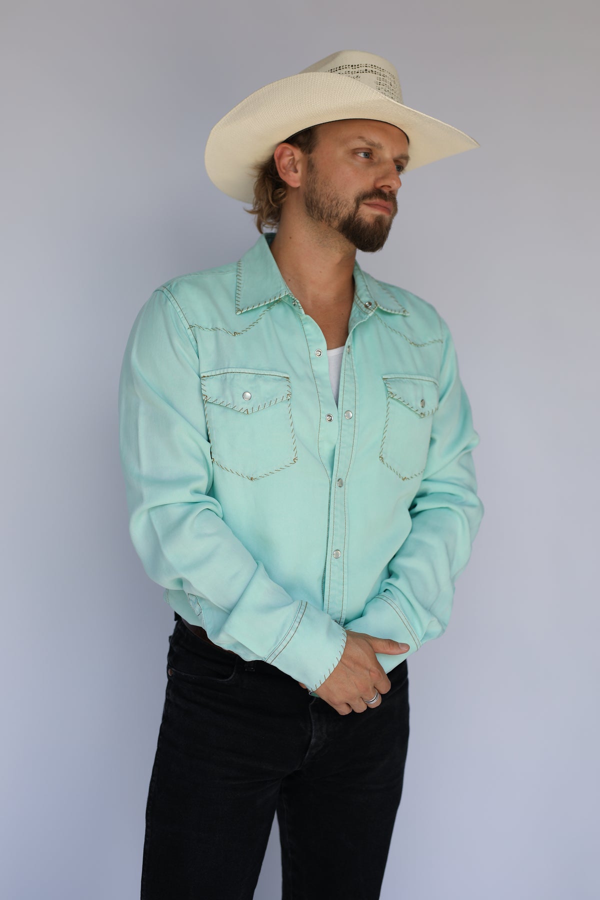 H Bar C Brooklyn turquoise western shirt worn with black jeans and a straw cowboy hat.