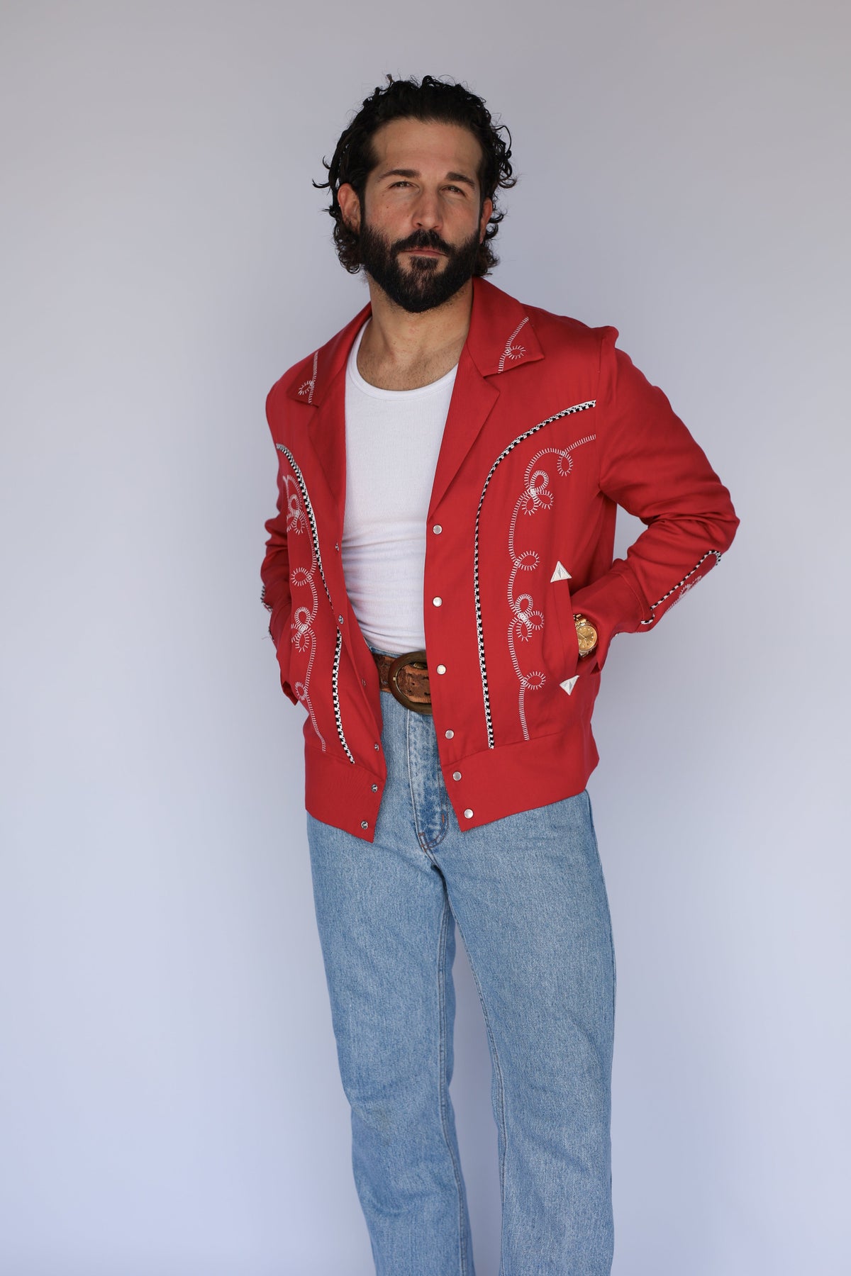 Front view of the H Bar C Bolero red western jacket, the iconic 1936 Bob Wills design, with jeans.