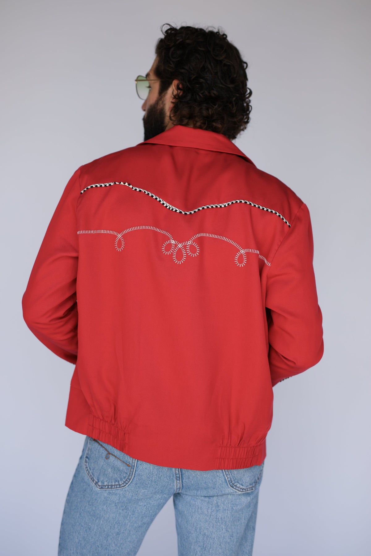 Back view of the H Bar C Bolero red jacket with white embroidered back yoke.