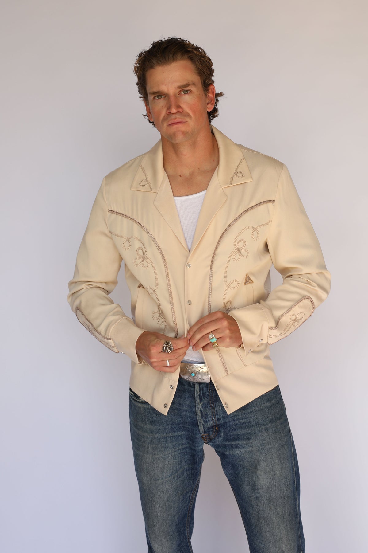 Man buttoning the H Bar C Bolero beige western jacket.