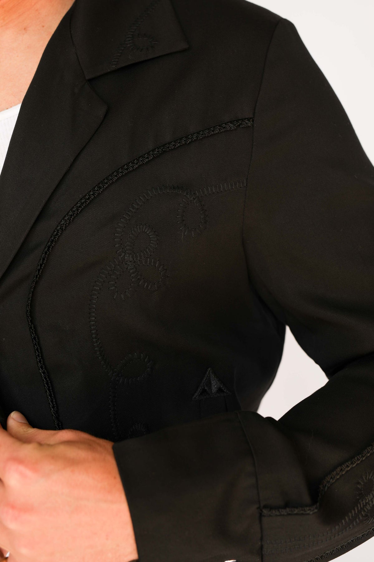 Collar and pocket detail of the H Bar C Bolero black on black jacket with tonal stitching.