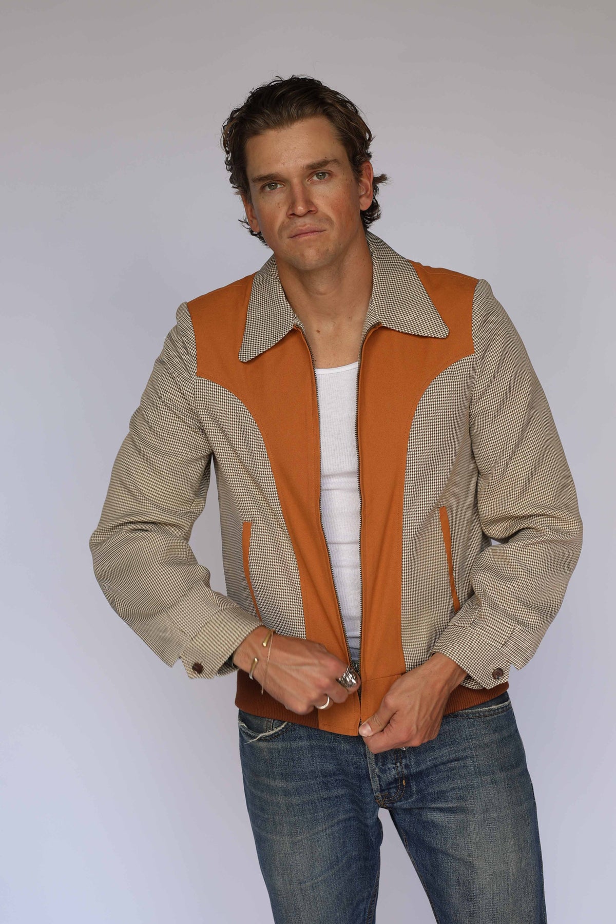 H Bar C Kentucky jacket in brown houndstooth with rust suede western yoke, zip front, and ribbed waistband, worn by a model