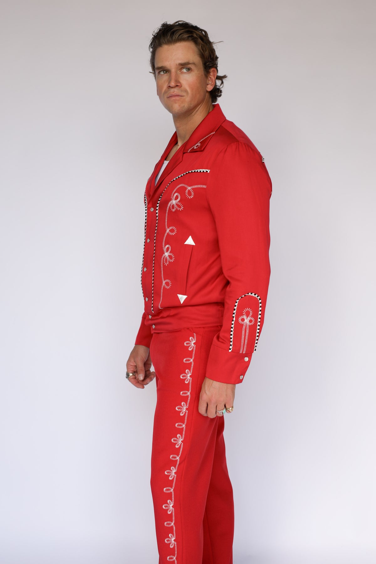 Man wearing the H Bar C Bolero red pants and matching red Bolero jacket, inspired by the 1936 Bob Wills design.