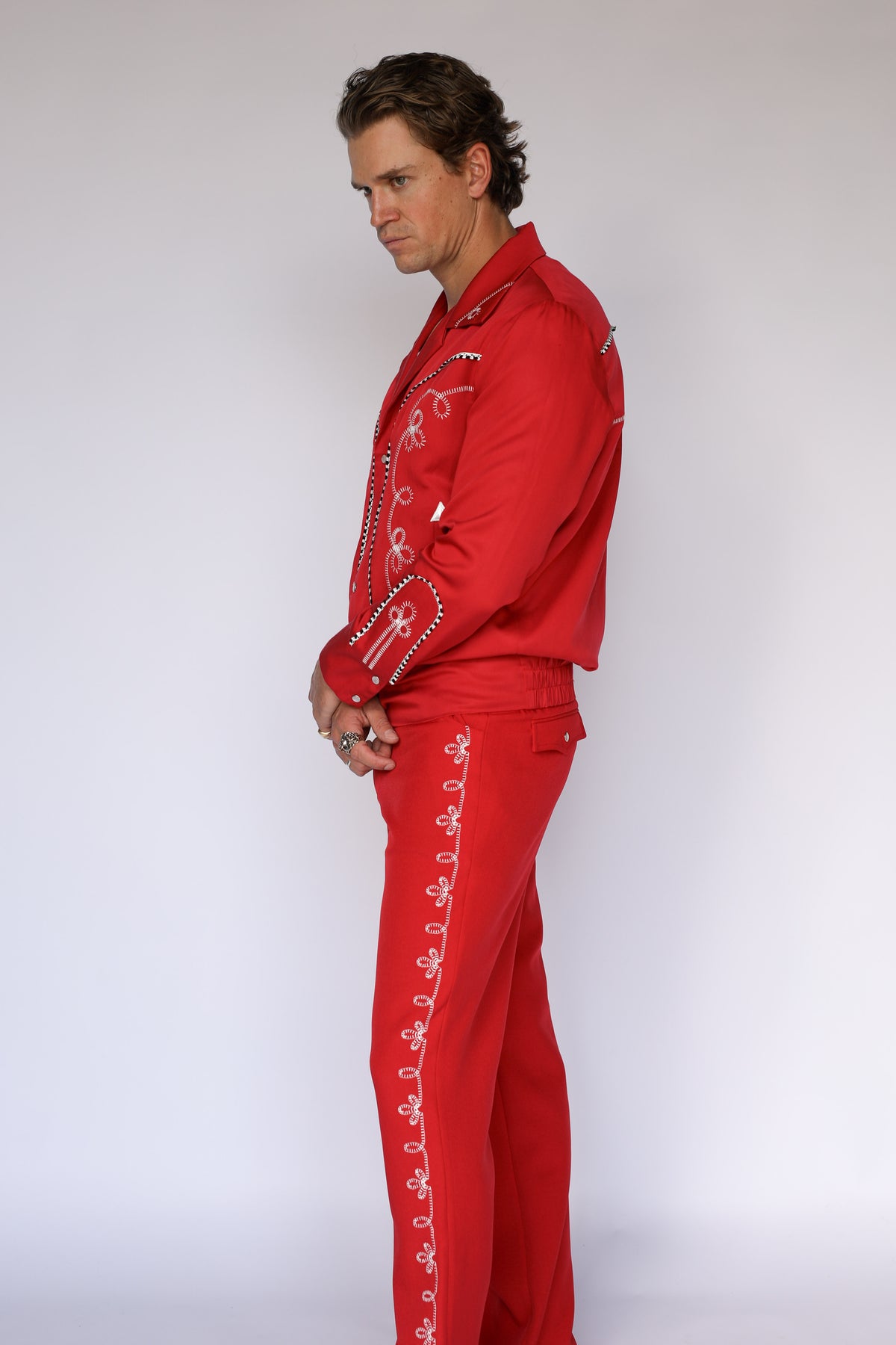 Front view of the H Bar C Bolero pants in red, straight leg western trousers with white embroidery.