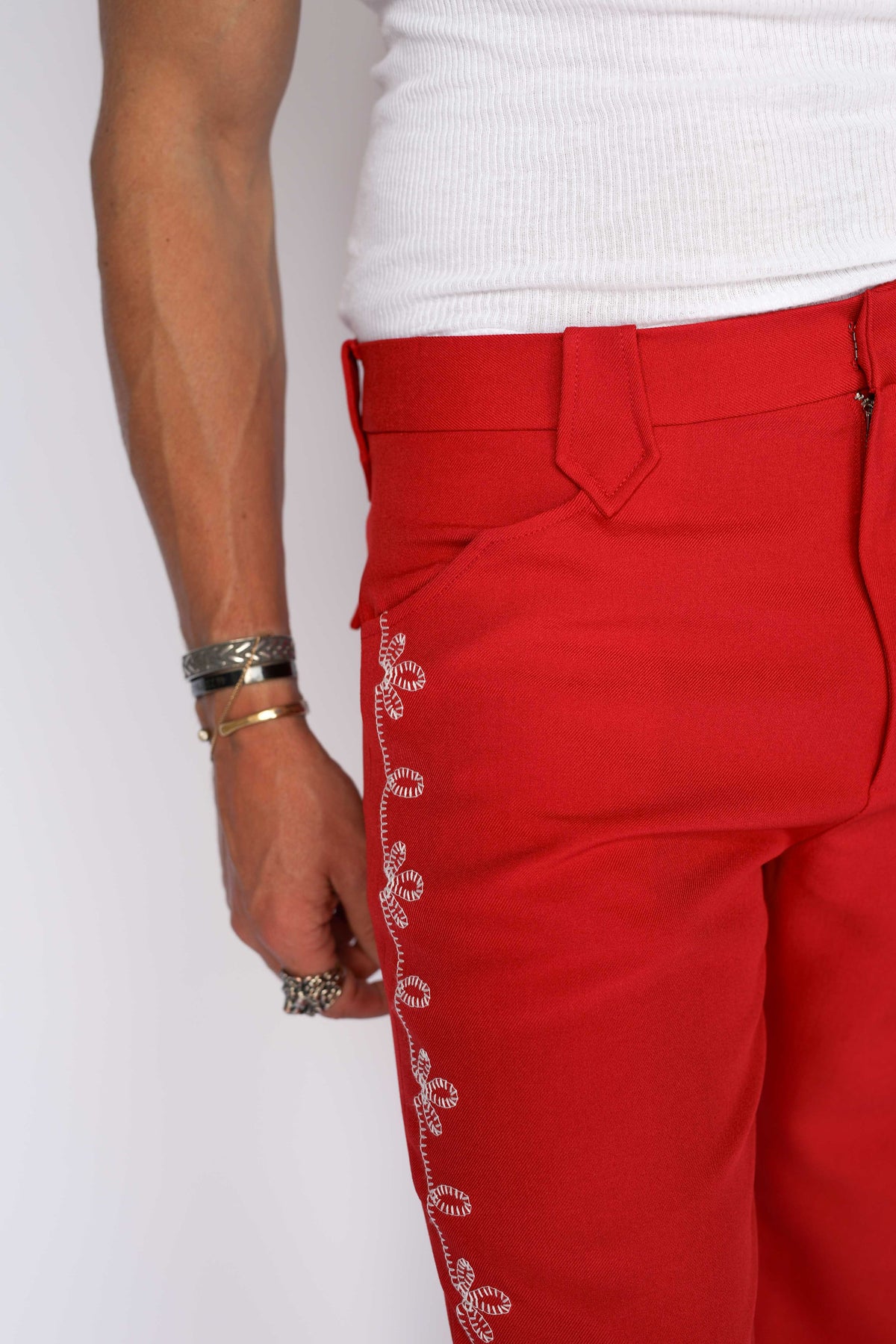 H Bar C Bolero red western pants with white embroidered flower trim along the outseam.