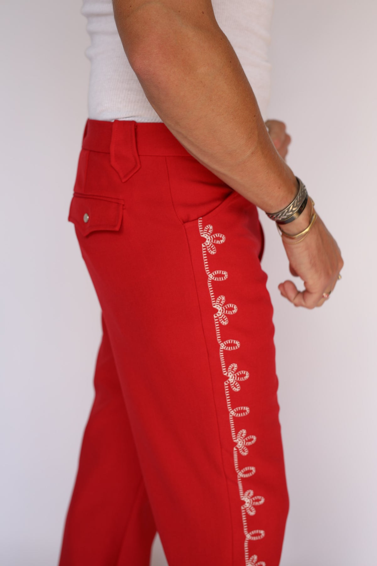 Close-up of the white flower embroidery on the H Bar C Bolero red pants.