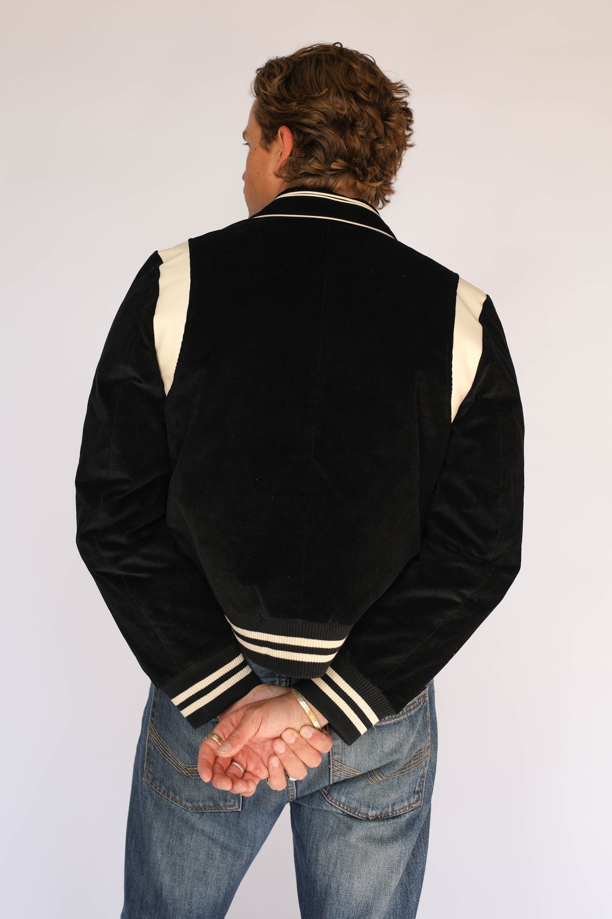 Back view of the H Bar C Silver Lake black corduroy jacket, vintage western wear with cream shoulder panels and striped ribbed waistband.