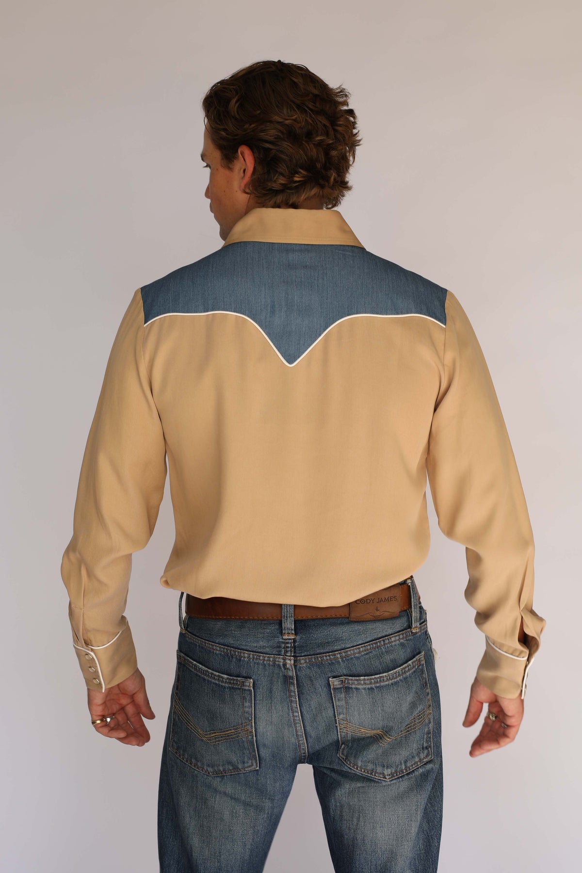 Back view of the H Bar C Telluride tan western shirt, vintage inspired western wear with a denim back yoke, white piping, and snap cuffs.