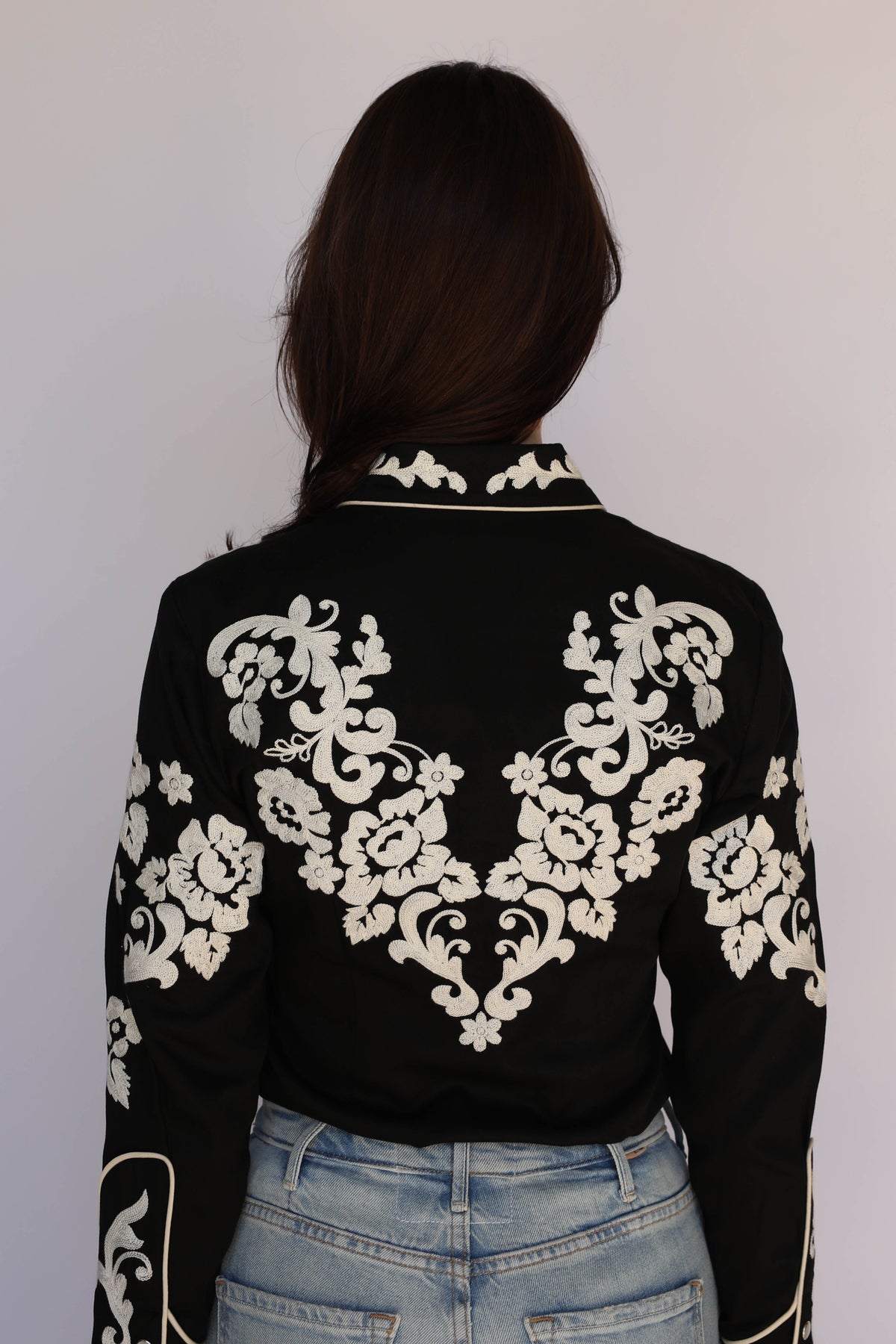 Back view of the H Bar C Fort Worth women's black shirt with ivory floral chain stitch across the back, vintage inspired western wear.