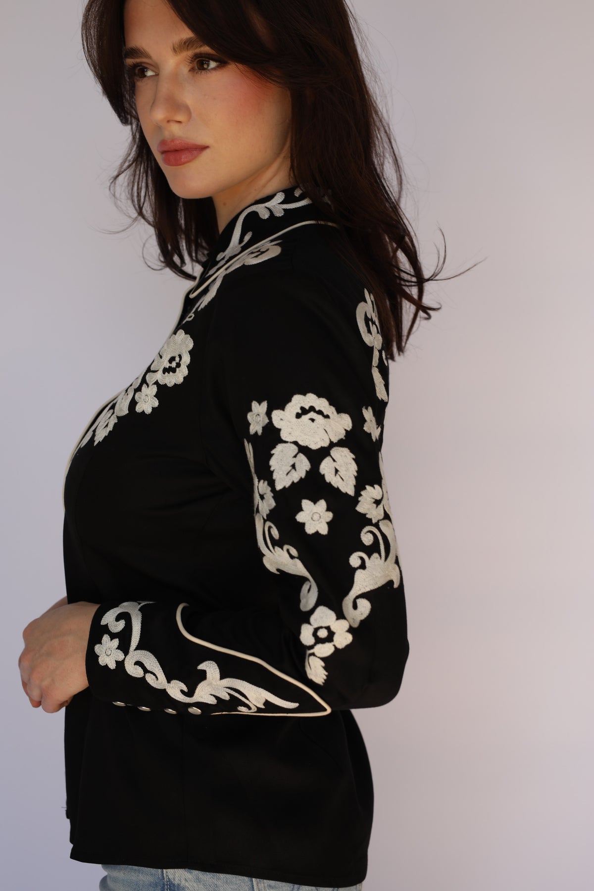 Three-quarter view of the H Bar C Fort Worth women's black shirt with ivory floral embroidery on the yokes and sleeves, vintage inspired western wear.