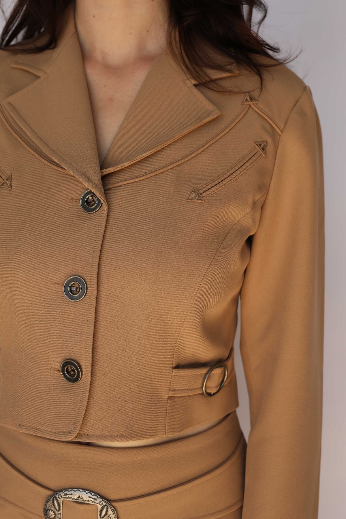 Close-up of the H Bar C Raleigh tan jacket lapel and embroidered arrow pocket, vintage inspired western wear detail.