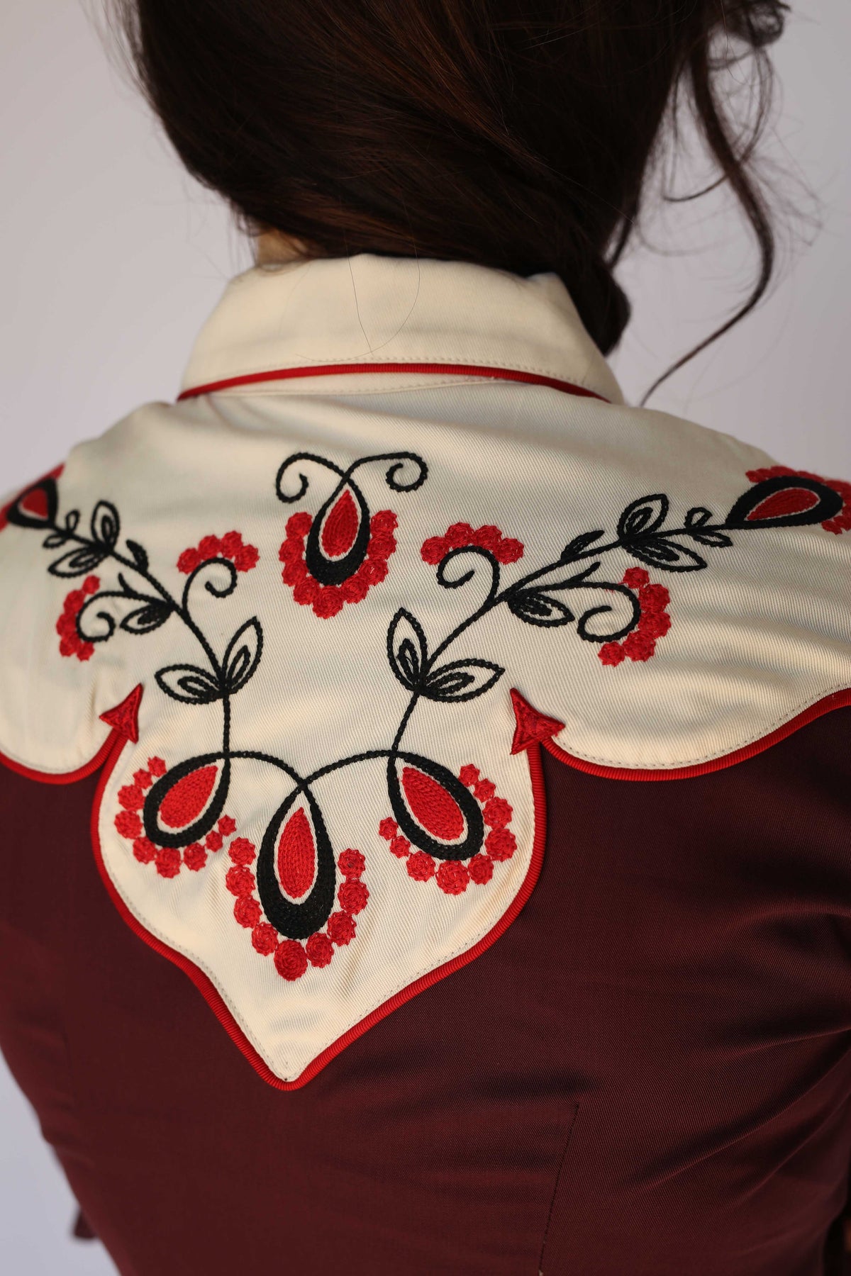 Detail of the red and black floral chain stitch on the cream yoke of the H Bar C San Jose burgundy western shirt, vintage inspired western wear.