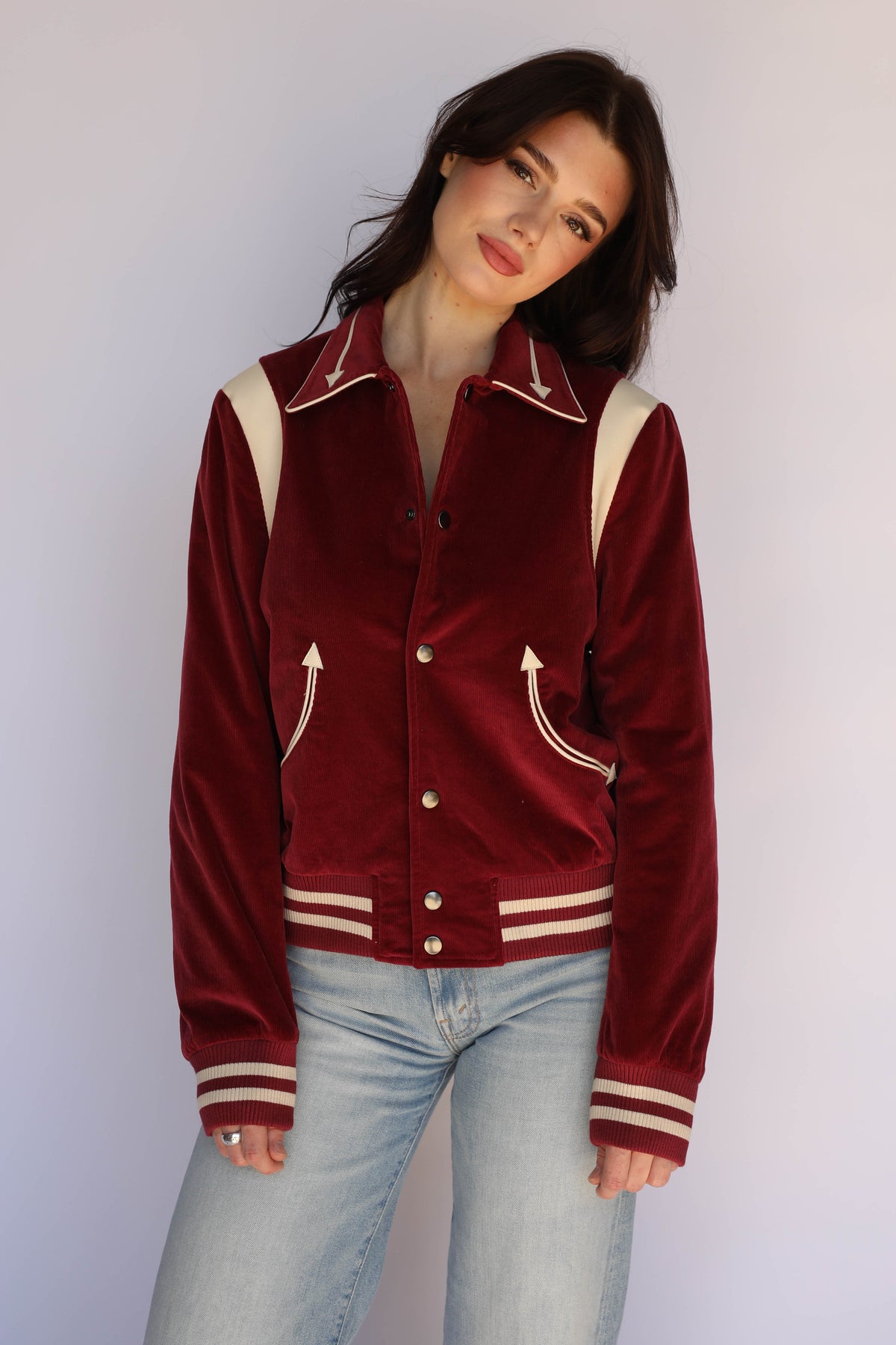 Woman wearing the H Bar C Silver Lake corduroy unisex jacket in maroon with light jeans.