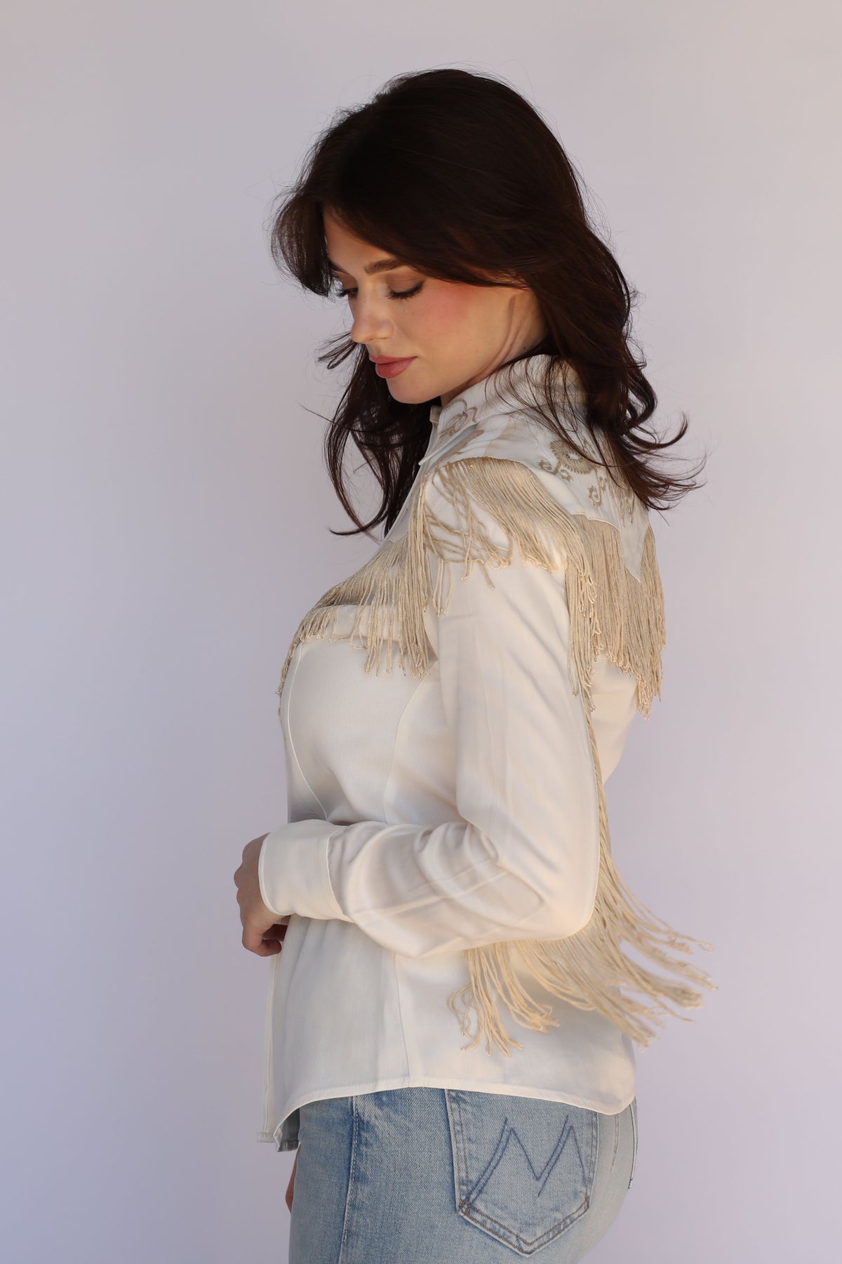 Side view of the H Bar C Taos women's white fringe western shirt showing sleeve fringe.