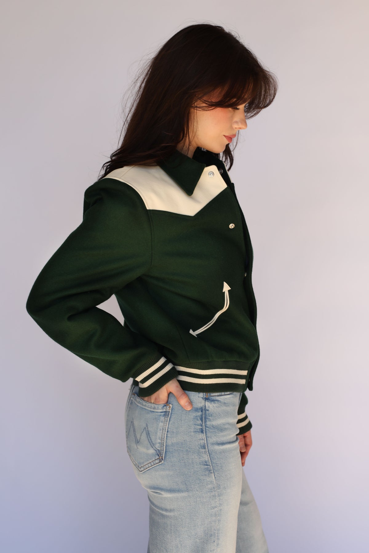 Side view of a woman in The Vail green wool jacket by H Bar C.