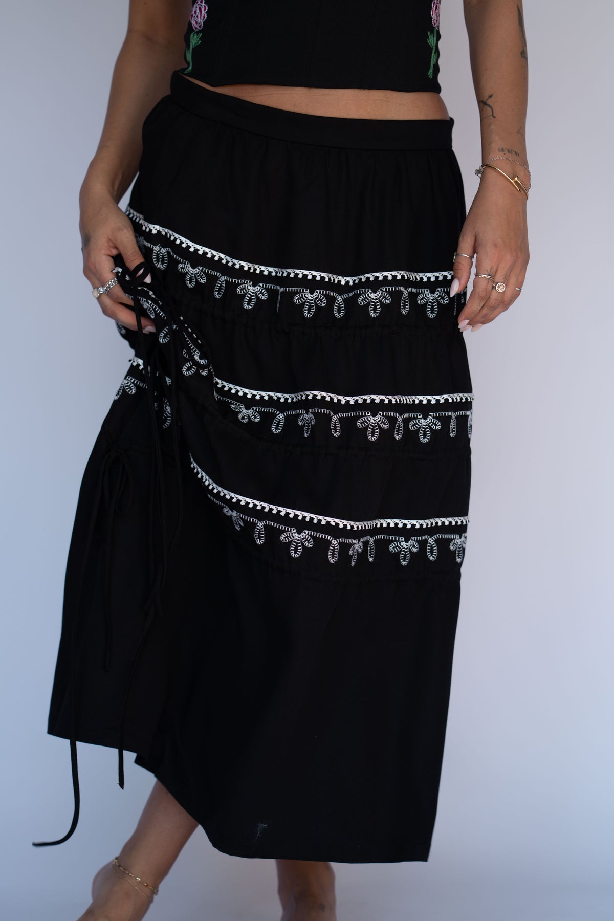 H Bar C Coachella black skirt with tiers gathered up using the adjustable ties.