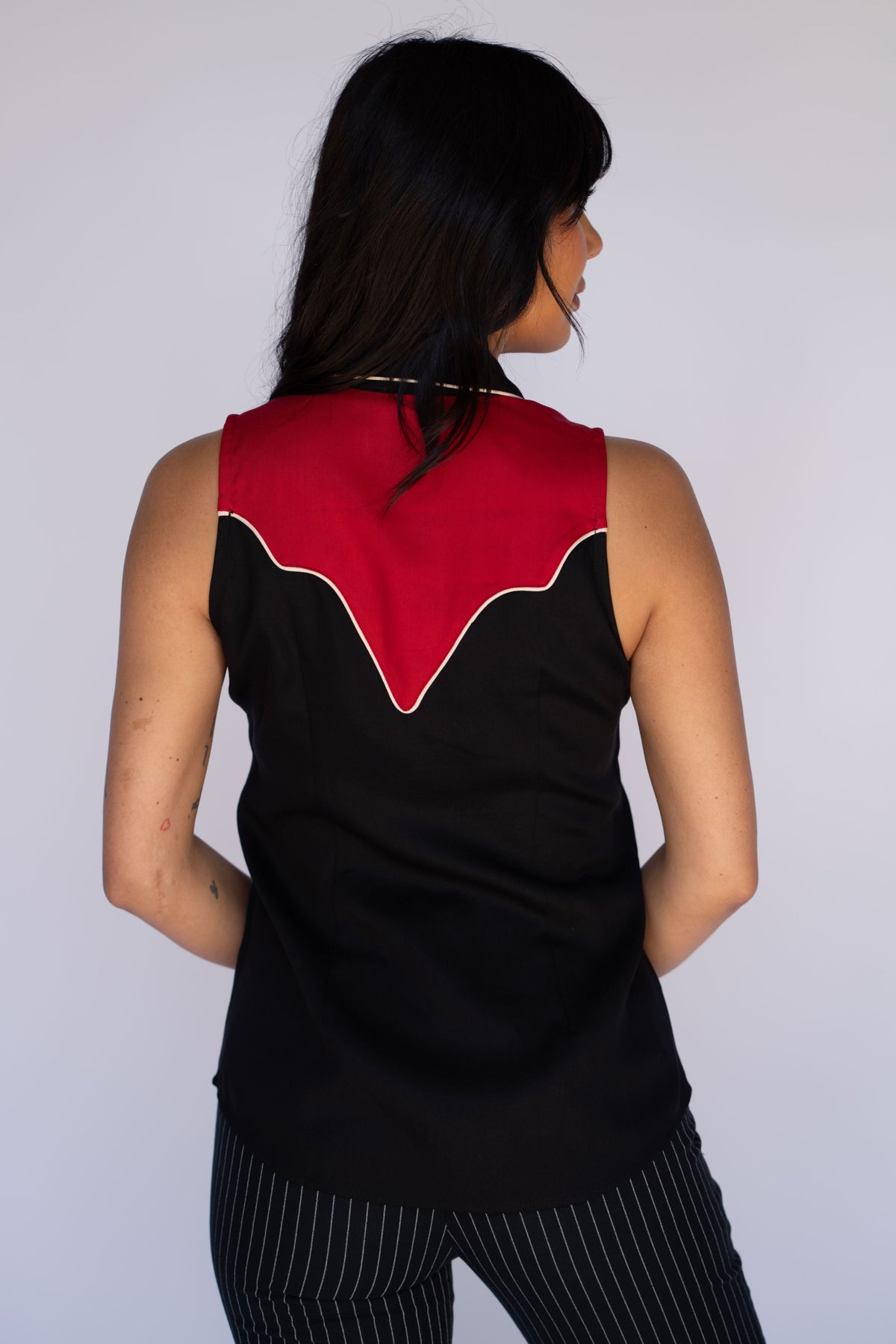 Back view of the H Bar C Atlanta black and red sleeveless shirt with red back yoke.