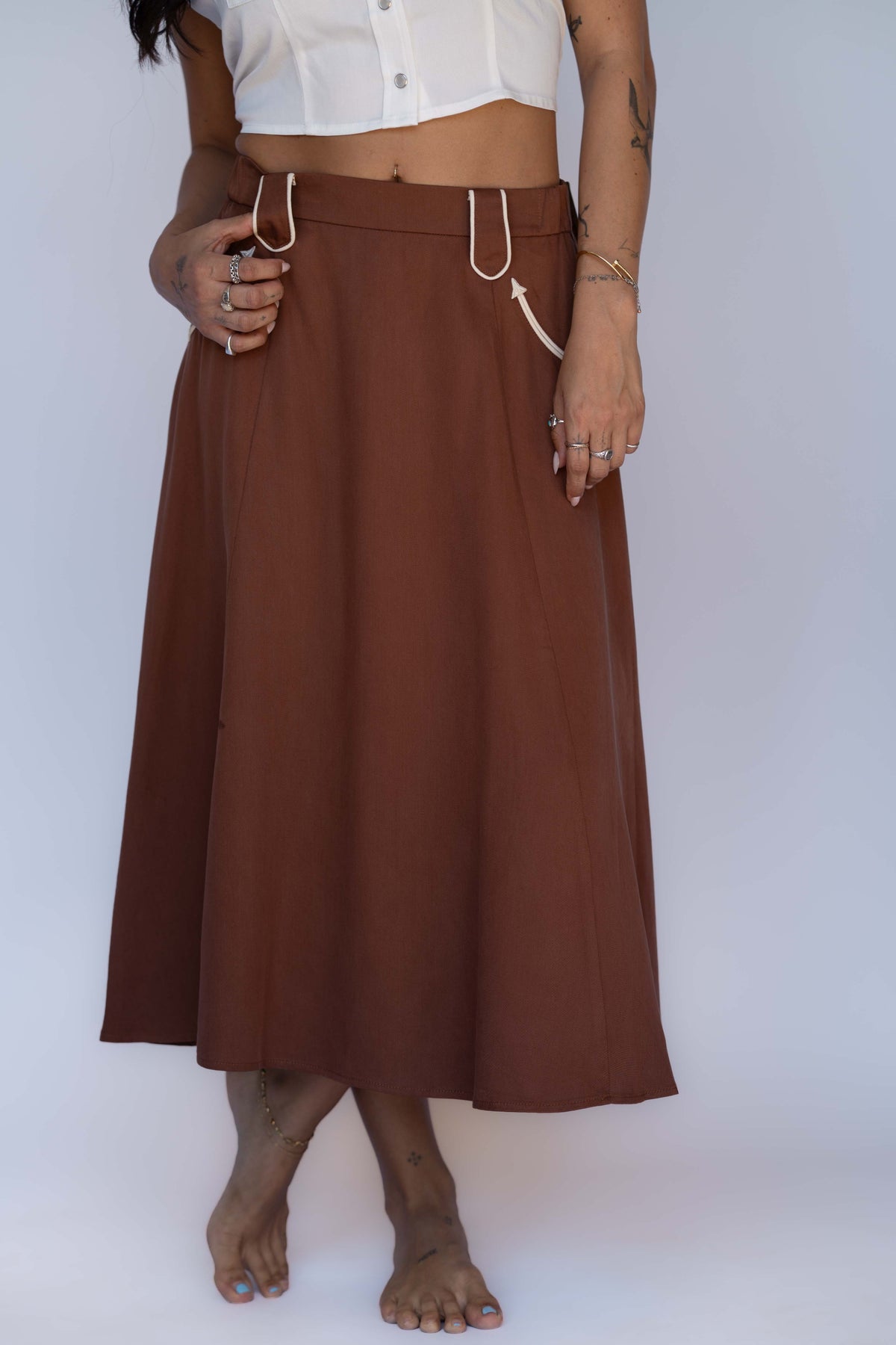 Waist-down view of the H Bar C Santa Fe chocolate skirt with white piped western pockets.